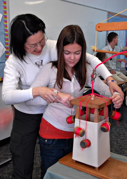 MISAWA AIR BASE, Japan – Alex Altobelli, age 12, learns how to make a braid with the help of a Japanese artisan during Japan Day here April 5, 2008. In Japanese, braid making is known as kumihimo and dates back to 550 C.E. (U.S. Air Force photo by Staff Sgt. Rachel Martinez)
