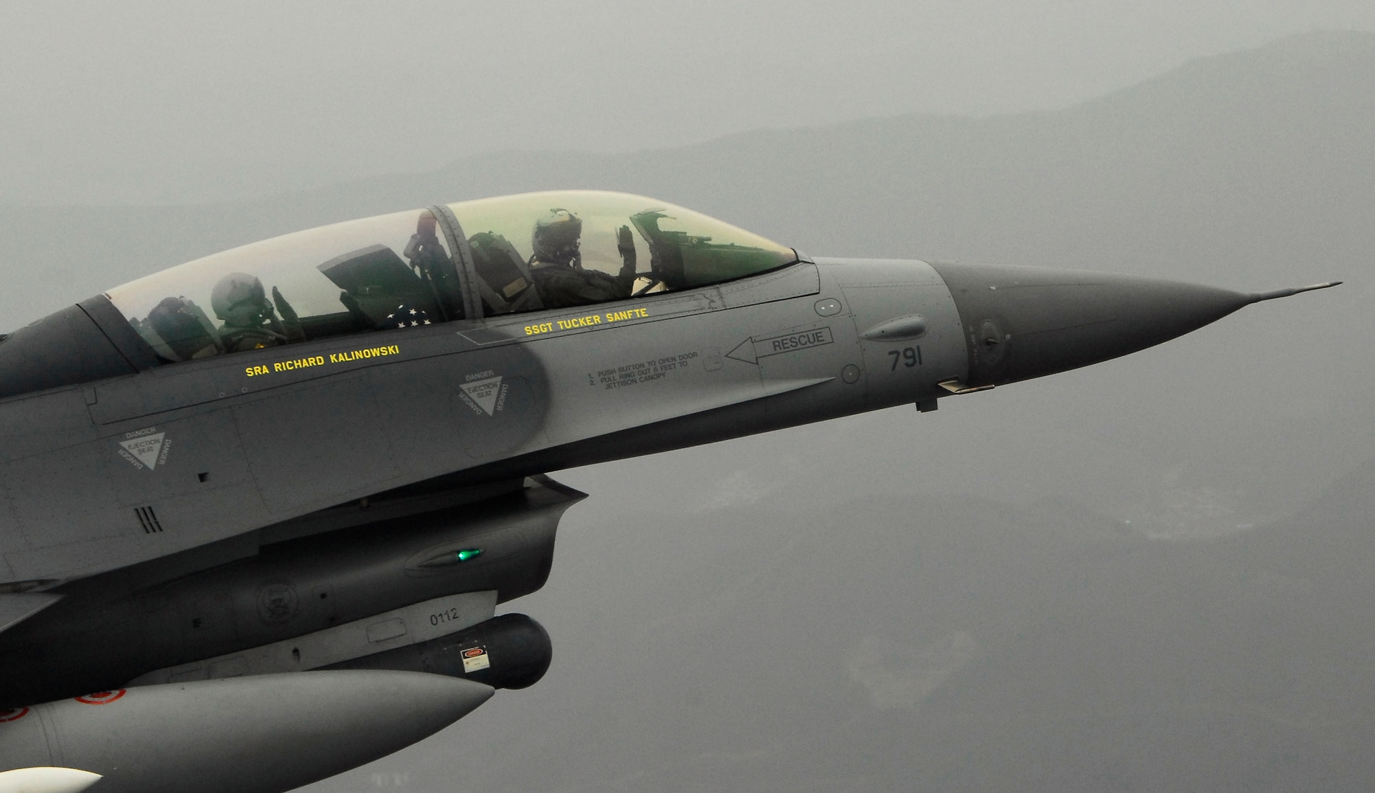 KUNSAN AIR BASE, Republic of Korea -- Colonel Kenneth Rizer, 8th Operations Group Commander, administers the oath of reenlistment to Staff Sgt. Robert Martin, 8th Aircraft Maintenance Squadron crew chief, during an F-16 incentive flight over the peninsula April 9. (U.S. Air Force photo/Tech. Sgt. Quinton T. Burris)  