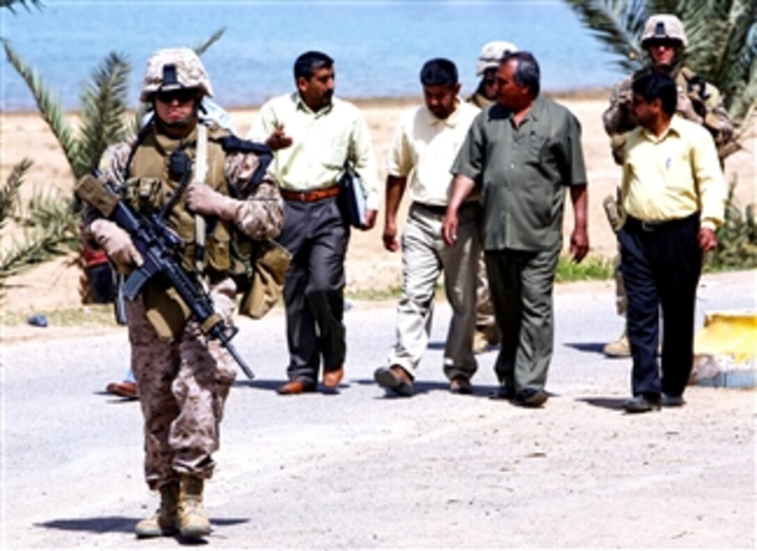 U.S. Marines escort private investors during a tour in Al Medinah As Siyahiyah, Iraq, April 6, 2008. The Marines, assigned to 1st Battalion, 11th Marine Regiment, are working with the town's director to try to get Iraqi business people to invest in the resort town and attract tourism.
