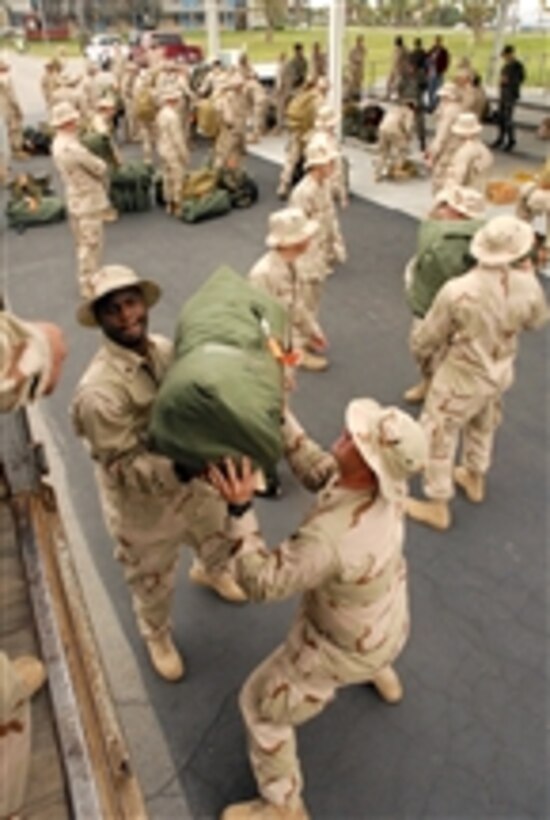 U.S. Navy Seabees from Naval Mobile Construction Battalion 3 load their sea bags onto a truck at Naval Base Ventura County in Port Hueneme, Calif., on April 6, 2008.  The Seabees are departing on a six-month deployment to Iraq.  