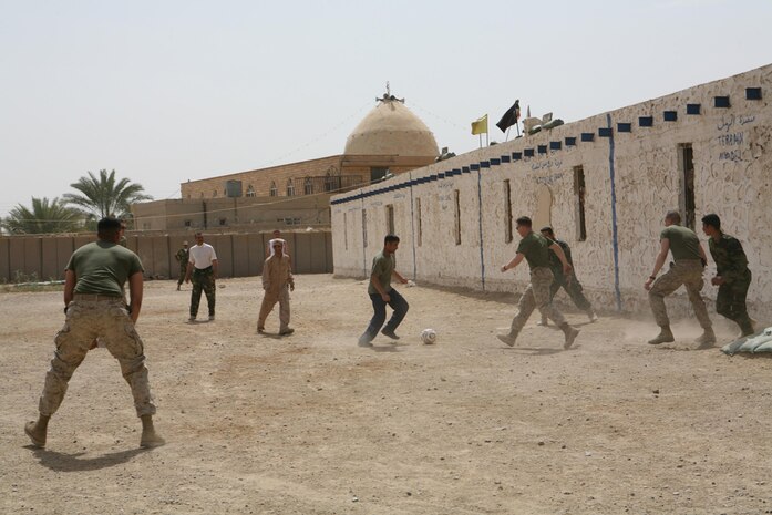 Marines with I Company, 3rd Battalion, 4th Marine, Regiment, Regimental Combat Team 5, and Iraqi Provisional Security Force troops play a game of soccer at Hit, Iraq, April 10. The PSF and Marines play once a week to build unity amongst the two units. At the end of the game, Marines took home the victory with the final score being 10-8.
