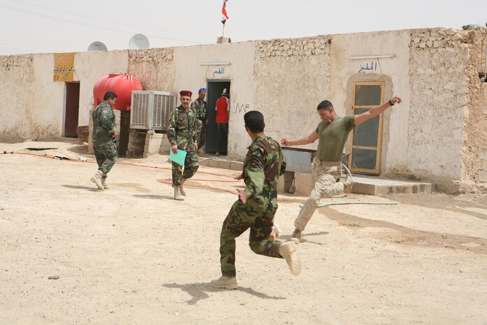 Lance Cpl. Jordan N. Axelrod-Dixon, 21, a rifleman from Fairlee, Vt., assigned to I Company, 3rd Battalion, 4th Marine Regiment, Regimental Combat Team 5, winds up for a kick during a soccer game played between Marines and the Iraqi Provisional Security Force at Hit, Iraq, April 10. The Marines managed to pull out a 10-8 victory, their first in four games.  The Marines and PSF play the game to increase unity amongst the two units.::r::::n::::r::::n::