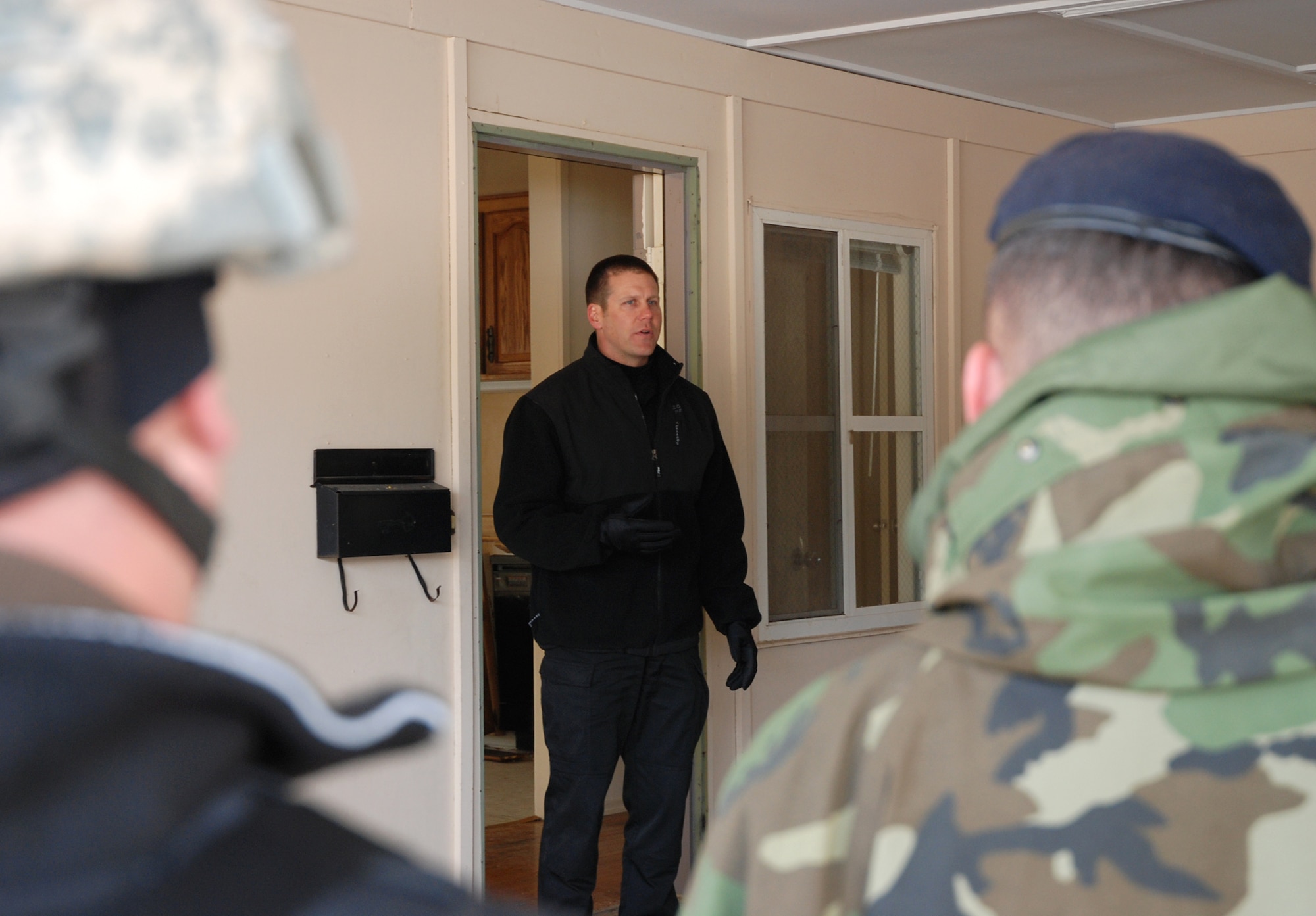 Sean Hartley, a canine unit trainer with the El Paso County Sheriff’s Office, covers several tactics in between scenario training with military and civilian law enforcement officials April 11 in the U.S. Air Force Academy base housing complex. Sergeant Hartley, together with several other agencies around the Colorado Springs area, participated in canine Special Weapons and Tactics, or ‘SWAT’ training to better understand the use of civilian and military working dogs during a tactical engagement with criminal or unfriendly forces. (U.S. Air Force photo/Senior Airman Stephen Collier)