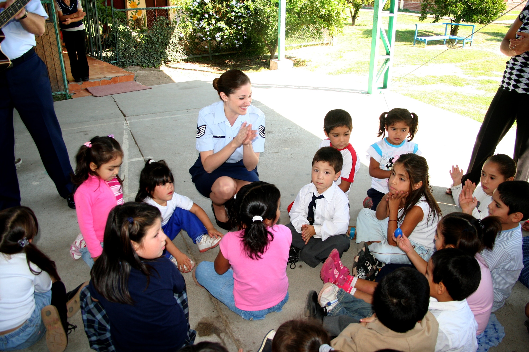 An Air Force noncommissioned officer spends time with Chilean orphan Thursday as part of an Air Forces Southern visit to Koinomadelfia Orphanage west of Santiago.  
Twenty Airmen here showcasing their aircraft at FIDAE, the largest air show in South America, visited more than 30 toddlers at the orphanage and handed out toys, stickers and patches. (U.S. Air Force photo Lt. Candace Cutrufo) 
