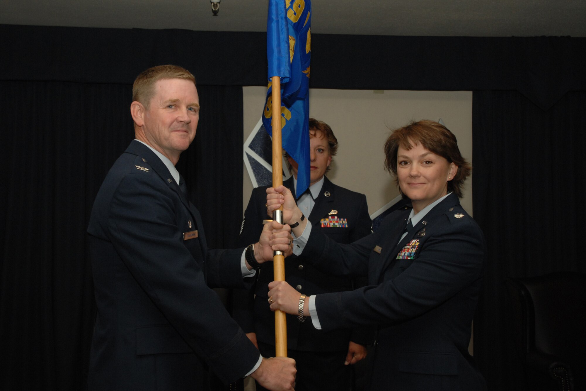 HOLLOMAN AIR FORCE BASE, N.M. --  Lt. Col. Kristin McCoy assumes command of the 49th Force Support Squadron during a squadron merger ceremony here April 4. The presiding officer for the ceremony was Col. Mark Engeman, 49th Mission Support Group commander.