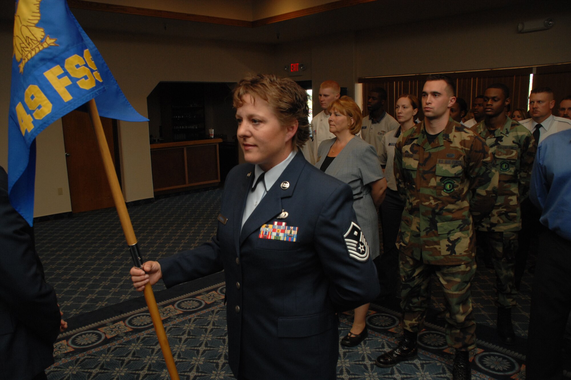 HOLLOMAN AIR FORCE BASE, N.M.-- As Master Sgt. Kimberly Marshall bears the guidon, members of the newly merged 49th Force Support Squadron stand in formation during a ceremony here April 4. The squadron, which merged the 49th Mission Supprot Squadron and the 49th Services Squadron, now holds more than 150 military and 350 civilian personnel.