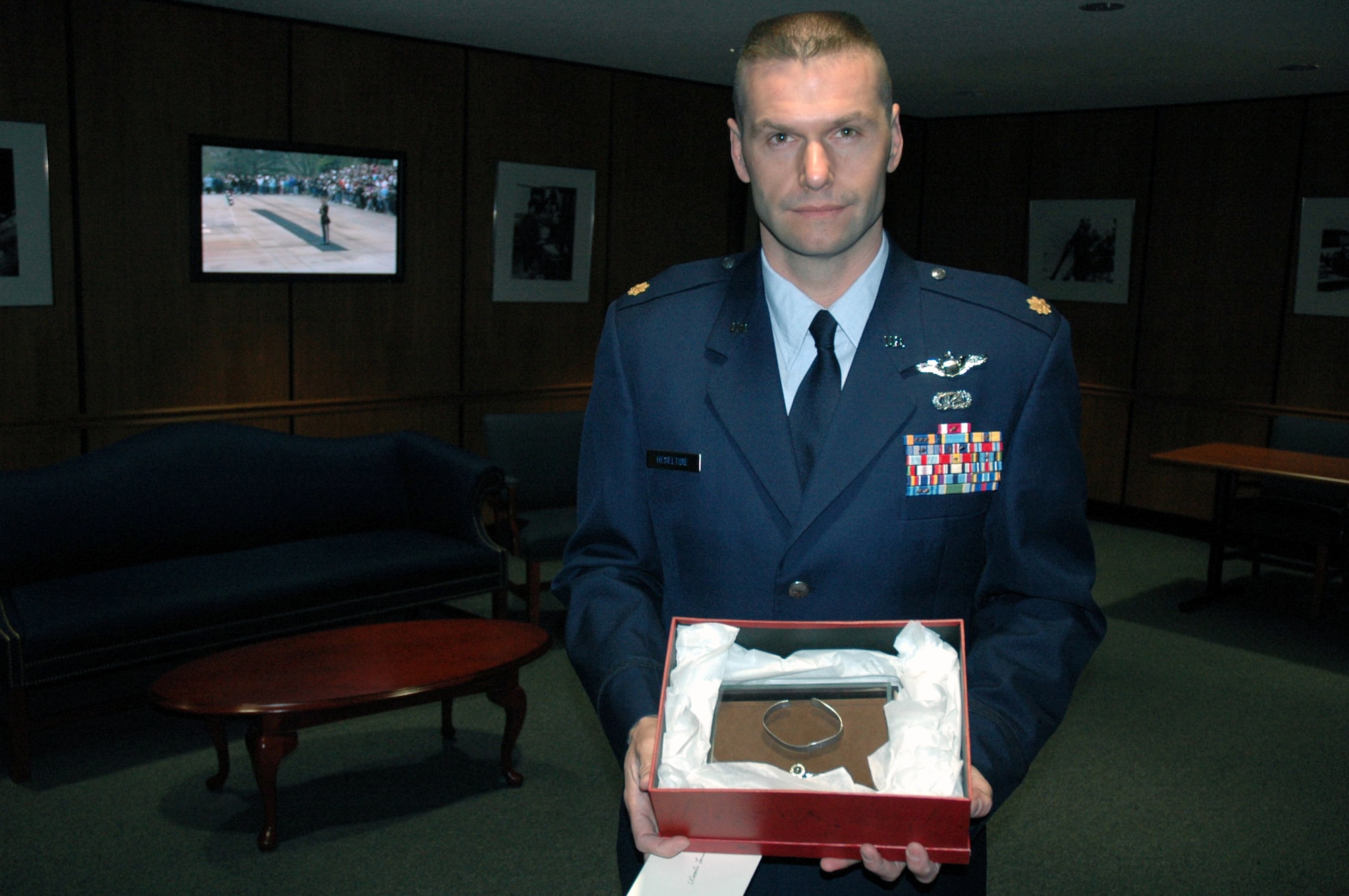 Maj. Phil Heseltine, U.S. Air Force Expeditionary Center executive officer to the commander, Fort Dix, N.J., shows the POW/MIA bracelet he wore for 18 years.  Major Heseltine presented the bracelet to the family of Maj. Robert F. Woods, whose name is on the bracelet, during the funeral for Major Woods at Arlington National Cemetery April 9, 2008.  (U.S. Air Force Photo/Tech. Sgt. Scott T. Sturkol)