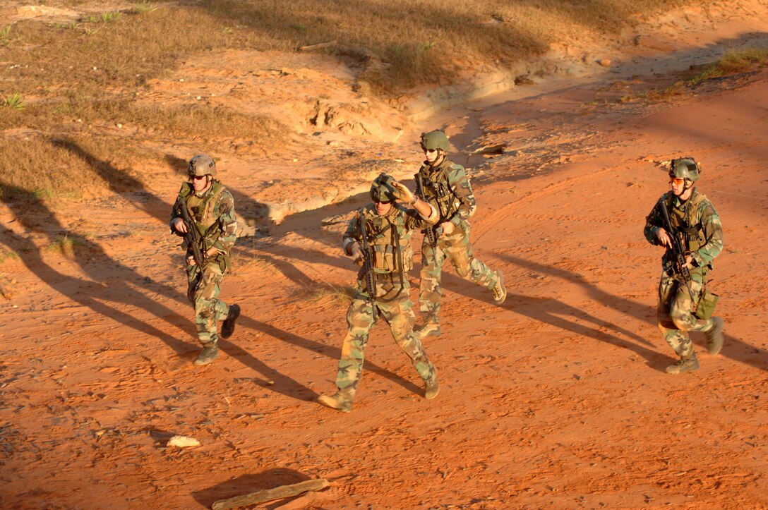 Combat controller trainees from the 720th Operations Support Squadron Advanced Skills Training flight rush to a waypoint away from "enemy" forces during a training exercise at a live-fire range on Eglin Air Force Base, Fla., Nov. 19, 2007.  AST is the last phase of training for combat controllers and special tactics officers before they report to operational special tactics squadrons. (U.S. Air Force photo/Airman Matthew Loken)