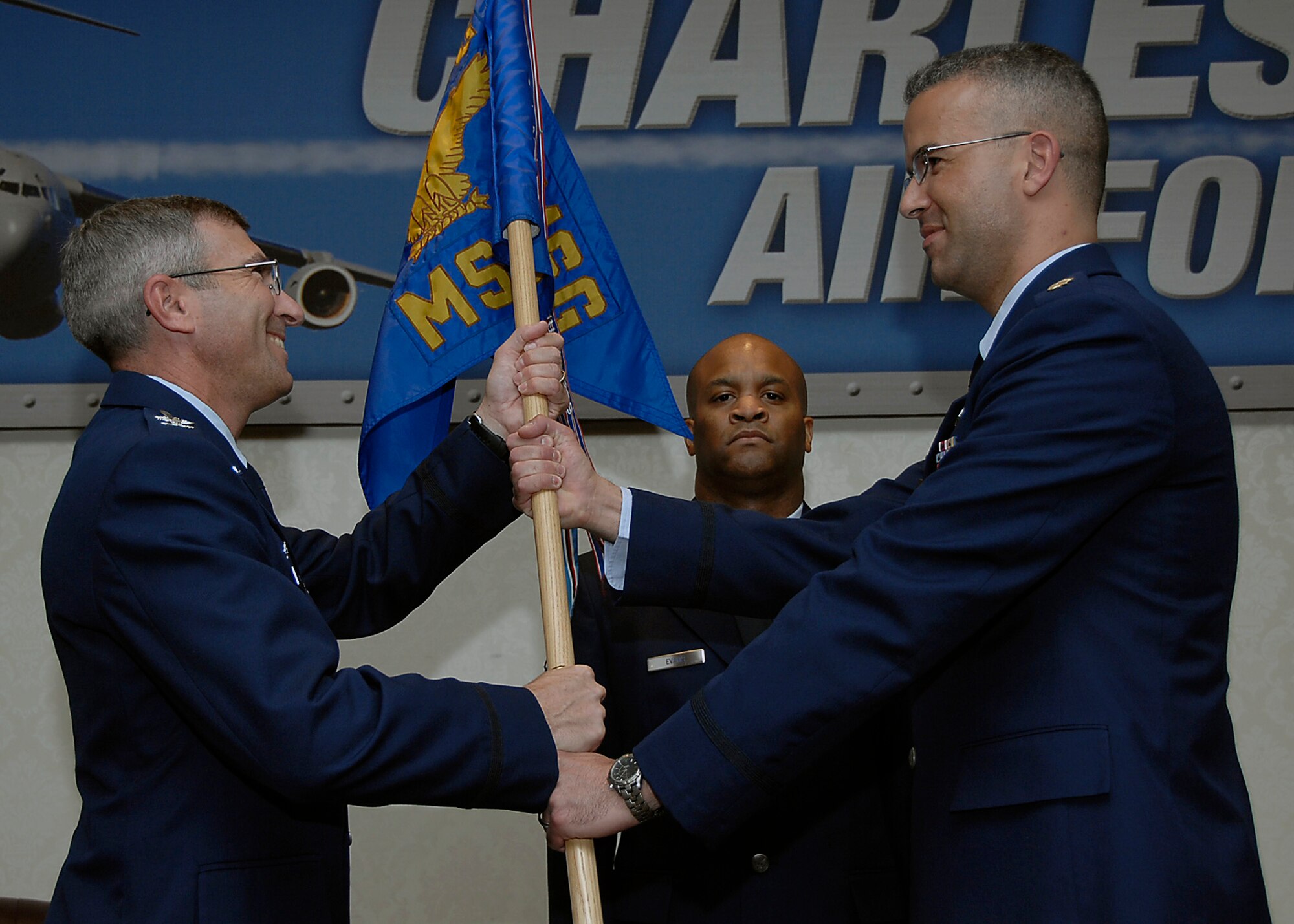 Col. Frank Jones retires the 437th Mission Support Squadron guidon from Maj. John Silverman during the 437th Mission Support Squadron and 437th Services Squadron merger ceremony on Charleston AFB April 10. Colonel Jones is the 437th Mission Support Group commander and Major Silverman is the newly formed 437th Force Support Squadron commander.  The 437 FSS will handle all people, community support and quality of life programs for Team Charleston. (U.S. Air Force photo/Airman 1st Class Katie Gieratz)