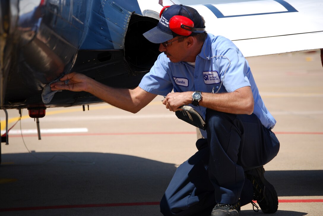 Steve Chandler, a T-37 Tweet crew chief with Lear Siegler Service, Inc., inspects an aircraft April 8. Mr. Chandler, a 25-year veteran with LSI, said the Tweet has been a workhorse for training the U.S. Air Force's and other country's undergraduate student pilots for more than 50 years, but the upgrade to the T-6A Texan II and the introductory trainer is a much-needed move. (U.S. Air Force photo/John Ingle)