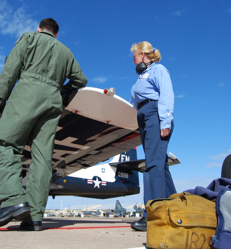 Doris Castle, right, a Lear Siegler Services, Inc., T-37 Tweet crew chief, makes a pre-fligth walk around April 11 with 89th Flying Training Squadron instructor pilot Capt. Dick Stringer. Ms. Castle has been a Tweet crew chief for about 25 years. (U.S. Air Force photo/John Ingle)