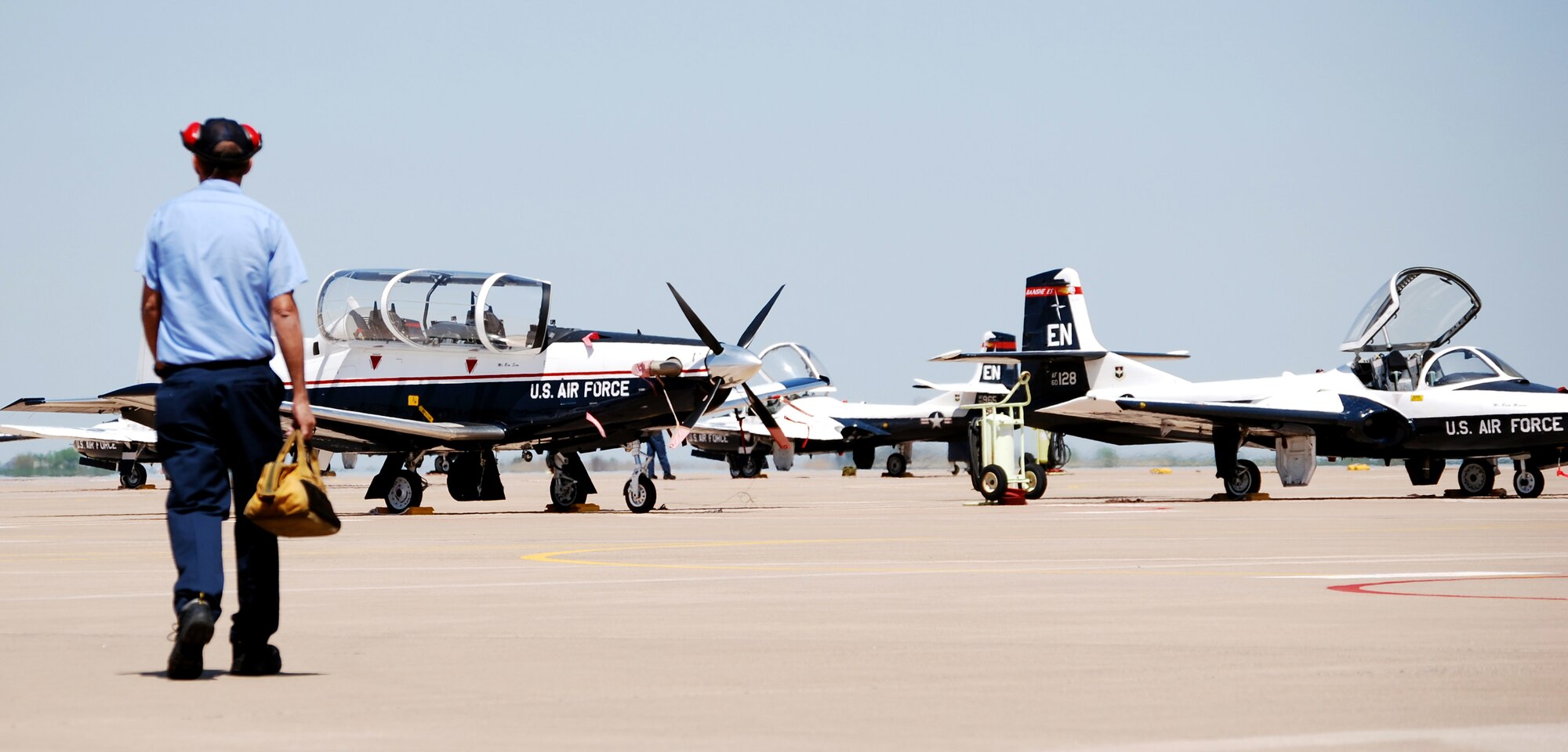 Steve Chandler, a T-37 Tweet crew chief with Lear Siegler Services, Inc., makes his daily walk out to the flight line to retrieve and launch the introductory training jet. Crew chiefs have mixed emotions about the departure of the antiquated trainer and the arrival of the T-6A Texan II, its replacement. (U.S. Air Force photo/John Ingle)