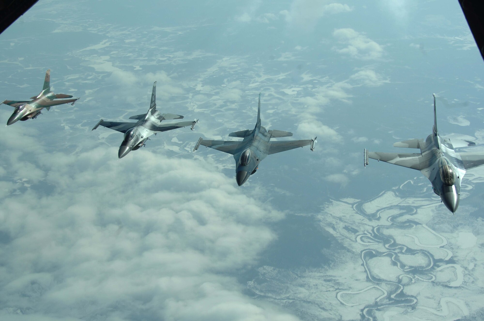 Four F-16 Aggressors from Eielson Air Force Base, Alaska,  fly in formation along side a KC-10 Extender during RED FLAG-Alaska 08-2, April 9, 2008. RED FLAG-Alaska is a series of Pacific Air Force field training exercises for U.S and allied forces that provide joint offensive counter-air, indirection, close air support, and large force employment training in a simulated combat environment.  (U.S. Air Force photo/Staff Sgt. Tia Schroeder)