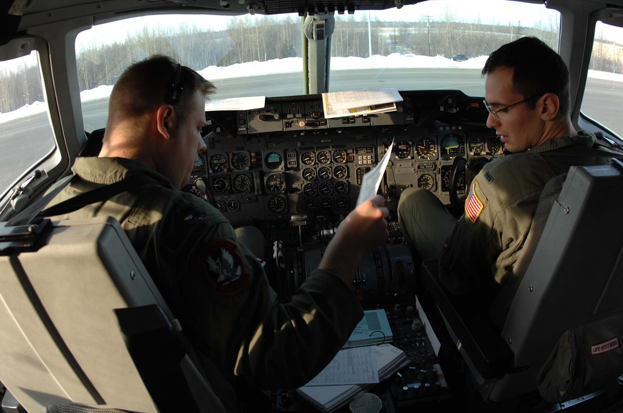 KC-10 Extender co-pilot 1st Lt. Joe Laveglia (right) and aircraft commander Will Weldon look over a preflight checklist prior to departure during RED FLAG-Alaska 08-2, April 9, 2008. Lieutenant Laveglia and Captain Weldon are stationed with the 2nd Air Refueling Squadron, McGuire Air Force Base, N.J.  (U.S. Air Force photo/Staff Sgt. Tia Schroeder)