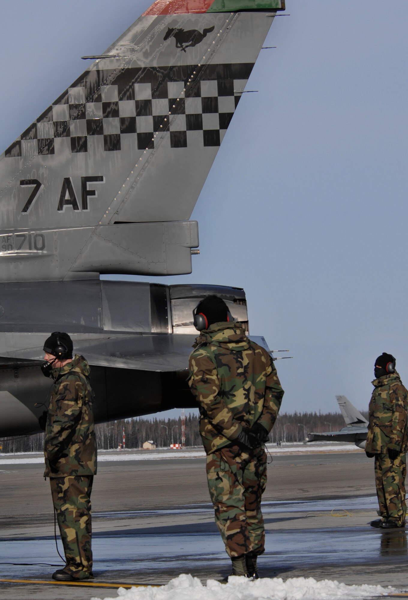 Senior Airmen Austin Harding (left), Joshua Melching and Joseph Robinson stand in below freezing temperatures on the Eielson Air Force Base flight line April 9, 2008 performing pre-flight checks for an F-16 Fighting Falcon prior to launch for RED FLAG-Alaska 08-2.  The Senior Airmen are from Osan Air Base, Korea.  RED FLAG-Alaska is a series of Pacific Air Forces field training exercises for U.S. forces and allies that provide joint offensive counter-air, close air support and large forces employment training in a simulated combat environment.

(U.S Air Force Photo by Tech Sgt. Eric T. Sheler)
