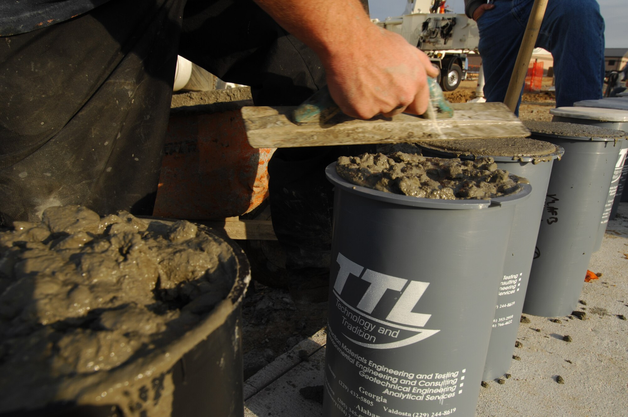 MOODY AIR FORCE BASE, Ga. -- A contractor takes random test samples of concrete that is being poured here in construction of a 2 bay fuel cell hanger floor April 10. The contractors had been working since 0100 that morning, and will take approximately ninety concrete trucks and twelve hours to complete the job. (U.S. Air Force photo/Staff Sgt. Joshua T. Jasper)