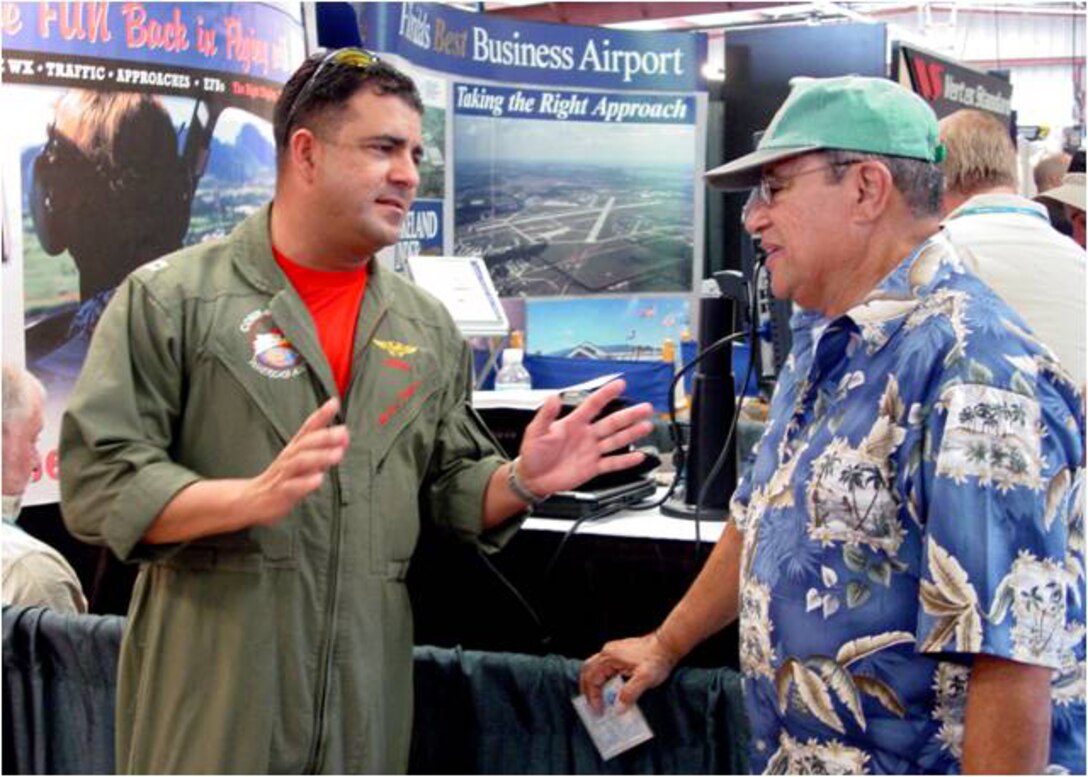 USN Lieutenant Hector Zayas discusses airspace issues with a foreign pilot attending Sun ?n Fun 2008.  The Continental U.S. NORAD Region (CONR) has expanded its public outreach team to include multilingual aviators capable of connecting with foreign pilots on topics of air defense and flight restricted zones.  (U.S. Air Force photo)

