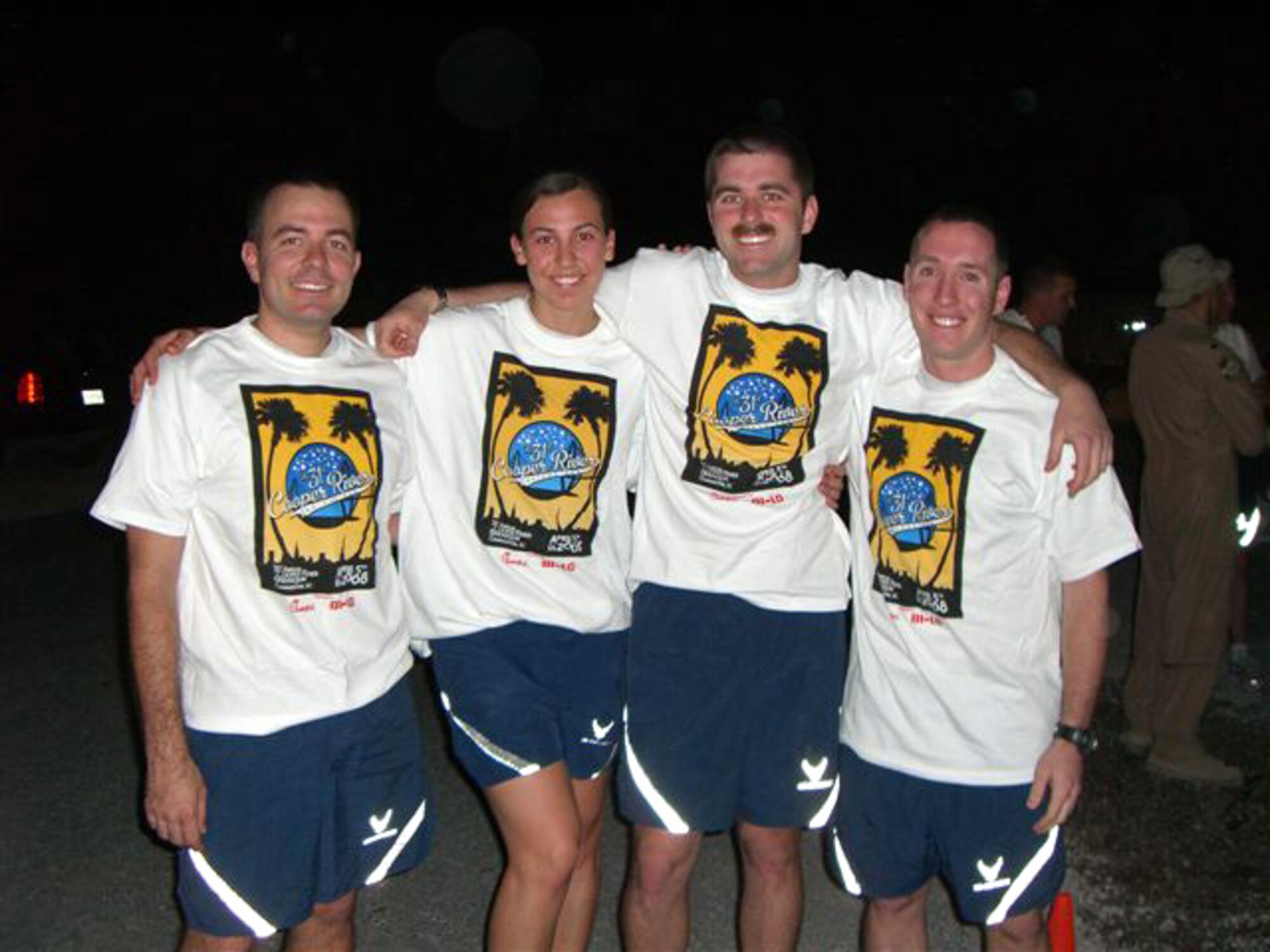 Members 816th Expeditionary Airlift Squadron, show off the custom-made Cooper River Bridge Run t-shirts April 5 at the race. (Courtesy photo)