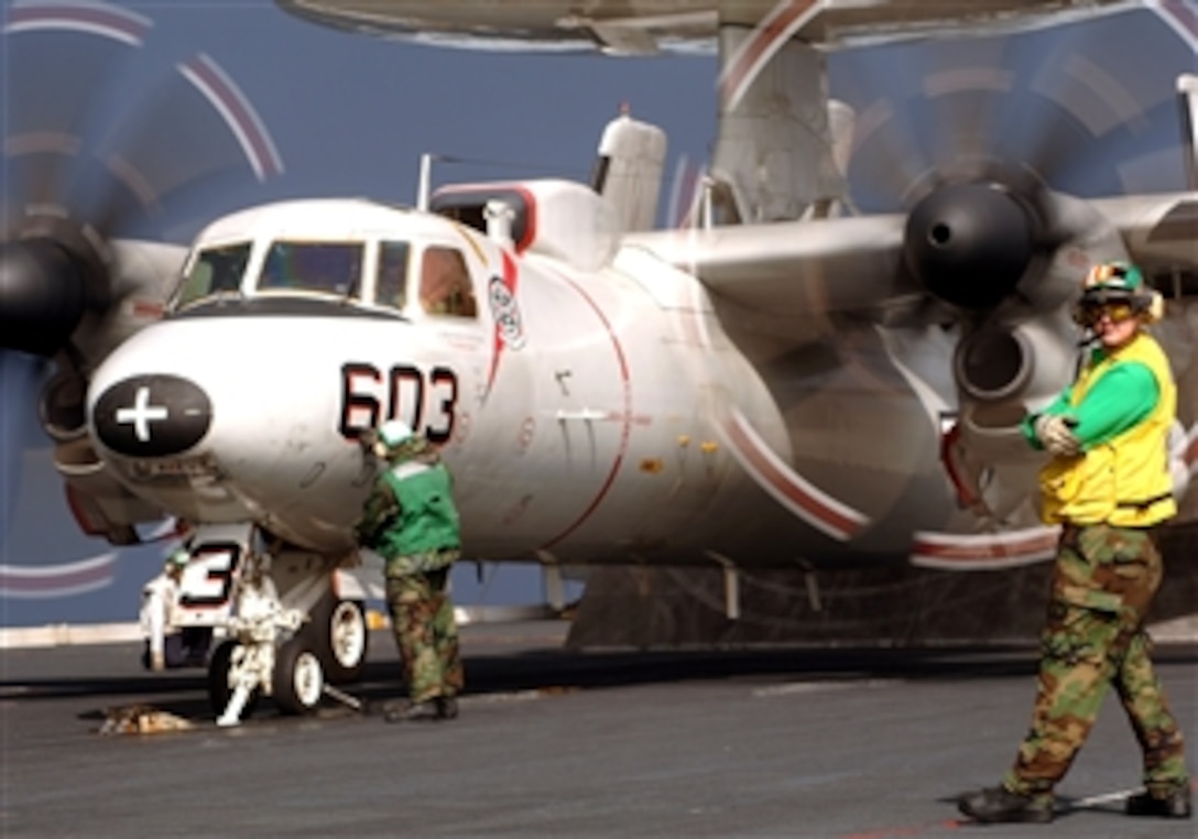 U.S. Navy Petty Officer 2nd Class Daniel Stettmier stands by for approval to launch an E-2C Hawkeye, assigned to the "Bear Aces" of Carrier Airborne Early Warning Squadron 124, from the deck of the USS Roosevelt, April 4, 2008.