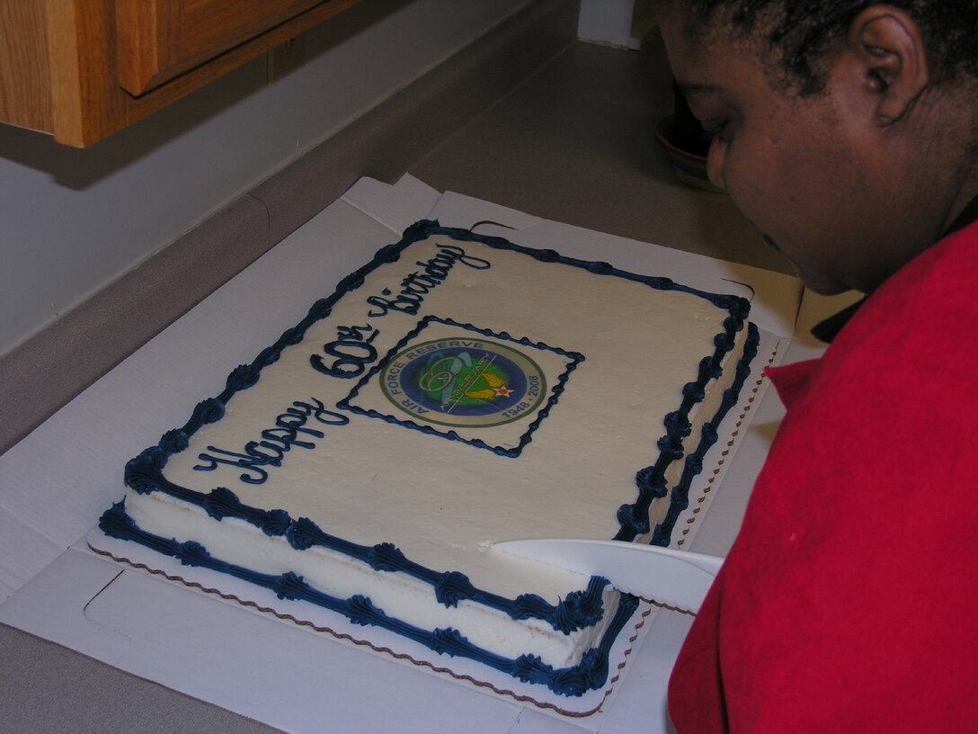 SEYMOUR JOHNSON AIR FORCE BASE, N.C. -- Ms. Lisa Jokines, secretary to the 916th Air Refueling Wing commander, prepares to cut the cake recognizing the Air Force Reserve's 60th birthday. The Air Force Reserve started on April 14, 1948. Members of the 916th celebrated by enjoying a piece of cake after their weekly staff meeting.