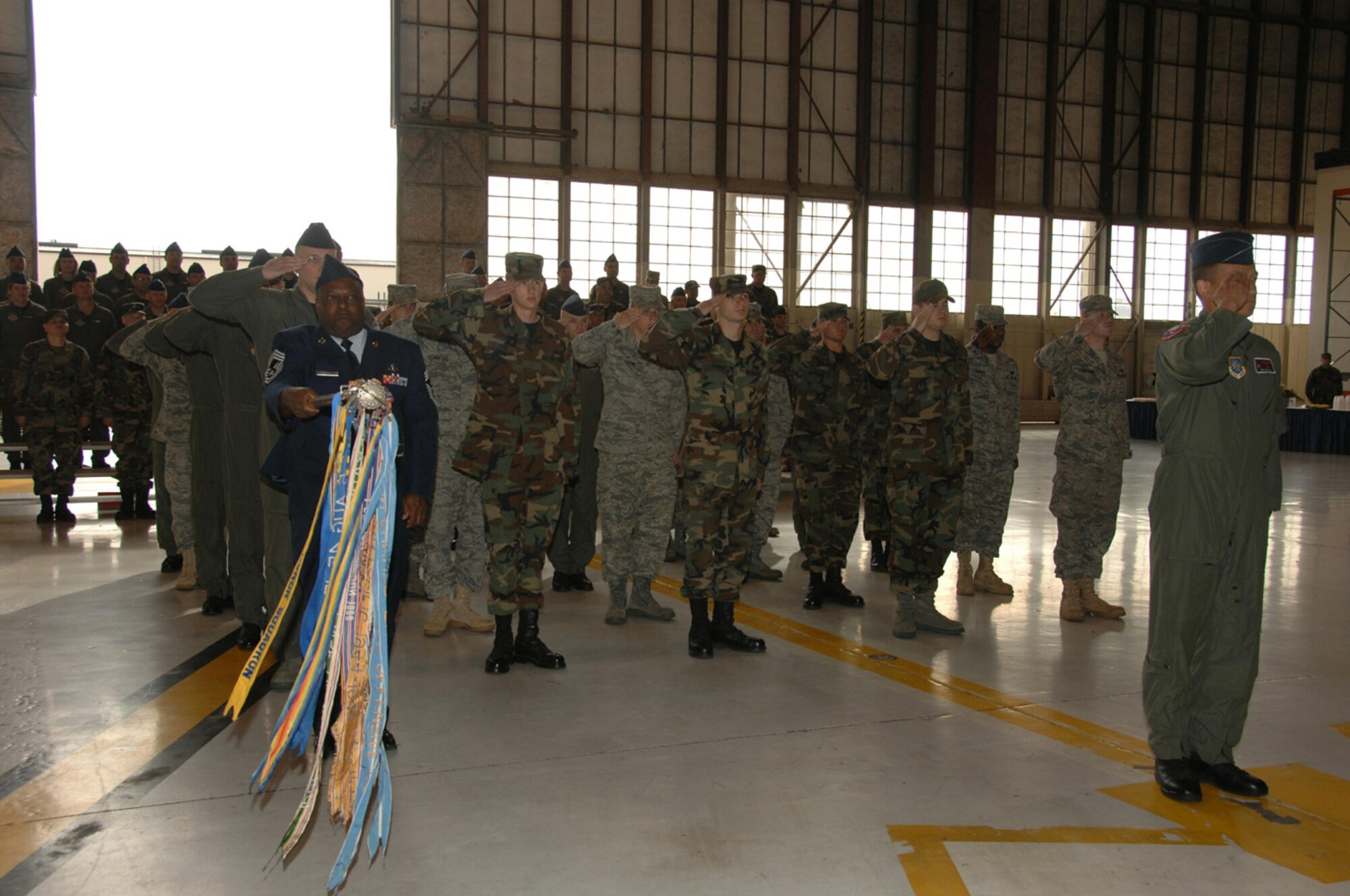 SEYMOUR JOHNSON AIR FORCE BASE, N.C. -- Members of the 911th Air Refueling Squadron salute their commander for the first time. Not seen, Lt. Col. Bill Uptmor, returns the salute from the stage. The 911th ARS activated as the first Active-associate unit in Air Force history on April 12, 2008. They help fly and maintain KC-135 air-to-air refueling tankers along with their Air Force Reserve counterparts from the 916th Air Refueling Wing.