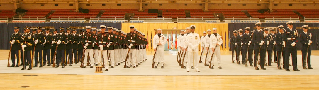 Marines, sailors, soldiers and coast guardsmen await meeting the more than 300 in attendance at the U.S. Armed Forces Joint Ceremonial Drill Competition in the National Guard Armory in Washington, D.C., April 12.  After the tough competition concluded, the judges awarded the 1st place to the U.S. Marine Corps Silent Drill Platoon.
