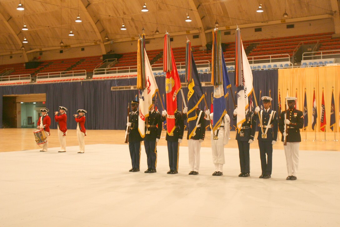 Marines, sailors, airmen, soldiers and coast guardsmen work together in a joint color guard at the U.S. Armed Forces Joint Ceremonial Drill Competition in the Washington, D.C., National Guard Armory, April 12.