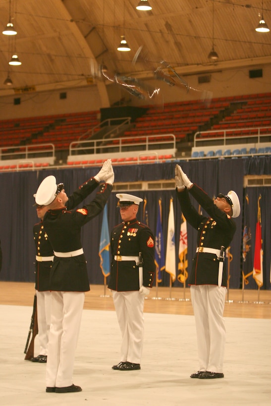 Cpl. Anthony Hill inspects his Marines at the U.S. Armed Forces Joint Ceremonial Drill Competition, April 12.  The U.S. Marine Corps Silent Drill Platoon won the event over the U.S. Navy Ceremonial Guard Drill Team, the U.S. Army Drill Team, and the U.S. Coast Guard Silent Drill Team.
