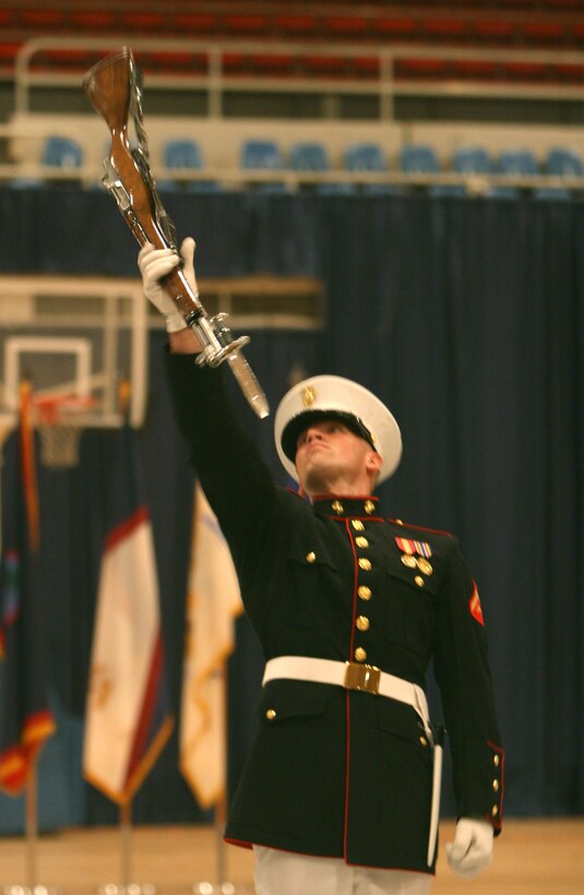 The U.S. Marine Corps Silent Drill Platoon Marines catch their rifles after tossing in the air at the U.S. Armed Forces Joint Ceremonial Drill Competition in the National Guard Armory, Washington, D.C., April 12.  The platoon won because of its hallmark precision and crowd pleasing inspection sequence.