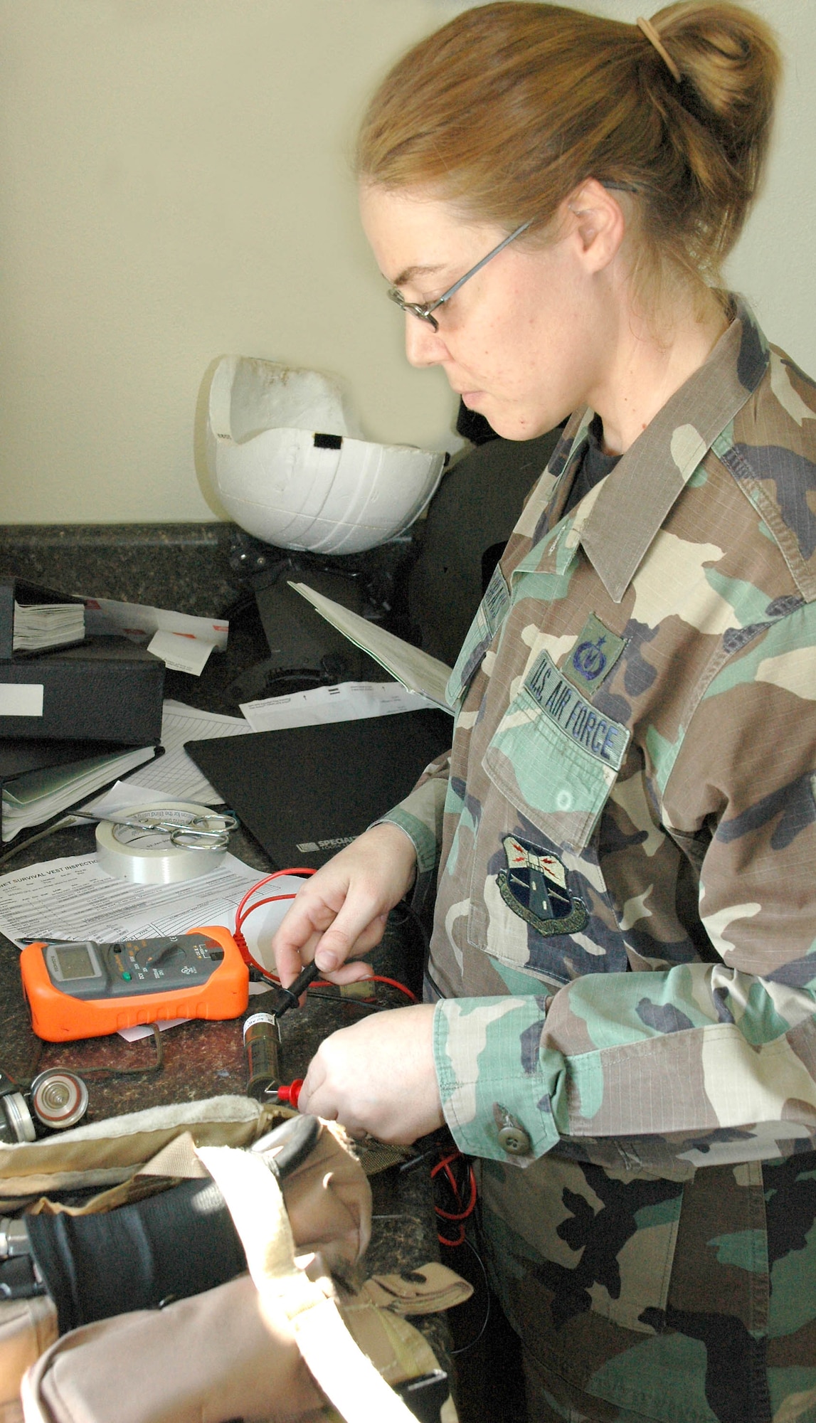 PATRICK AIR FORCE BASE, Fla - Air Force Reservist Staff Sgt. Amber Snodgrass, aircrew life support equipment technician, 920th Operational Support Flight, checks the voltage on a battery from an AN/PRC-90-2 aircrew survival radio during a recent 920th Rescue Wing Unit Training Assembly.  Citizen Airmen like Sergeant Snodgrass train to fight and are ready to deploy whenever called upon.  About 2,200 mobilized reservists and about 2,700 volunteers are working in support of military operations around the world. (U.S. Air Force Photo/Master Sgt. Raymond F. Padgett)