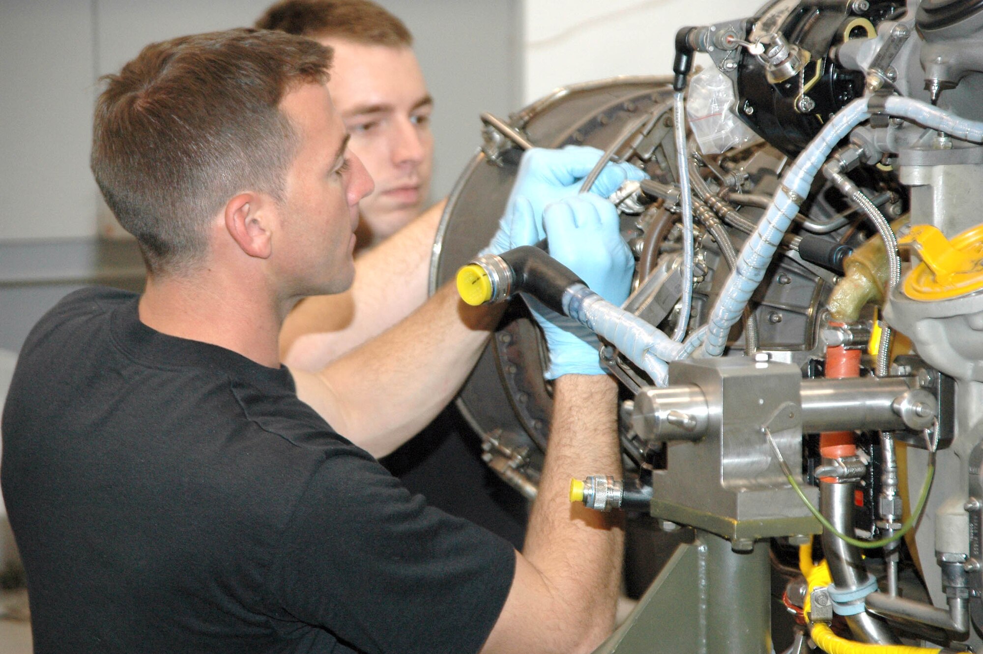 PATRICK AIR FORCE BASE, Fla. - Air Force Reservists Senior Airman Mathew Wandell and Staff Sgt. David Rowlands, 920th Maintenance Propulsion Shop, perform maintenance on a T-700 engine from an HH-60G Pave Hawk rescue helicopter during a recent 920th Rescue Wing Unit Training Assembly.  The Air Force Reserve offers taxpayers an incredible return on investment.  Air Force Reserve programs provide about 20 percent of the AF's capability for about 4 percent of the total AF budget.   (U.S. Air Force Photo/Master Sgt. Raymond F. Padgett)