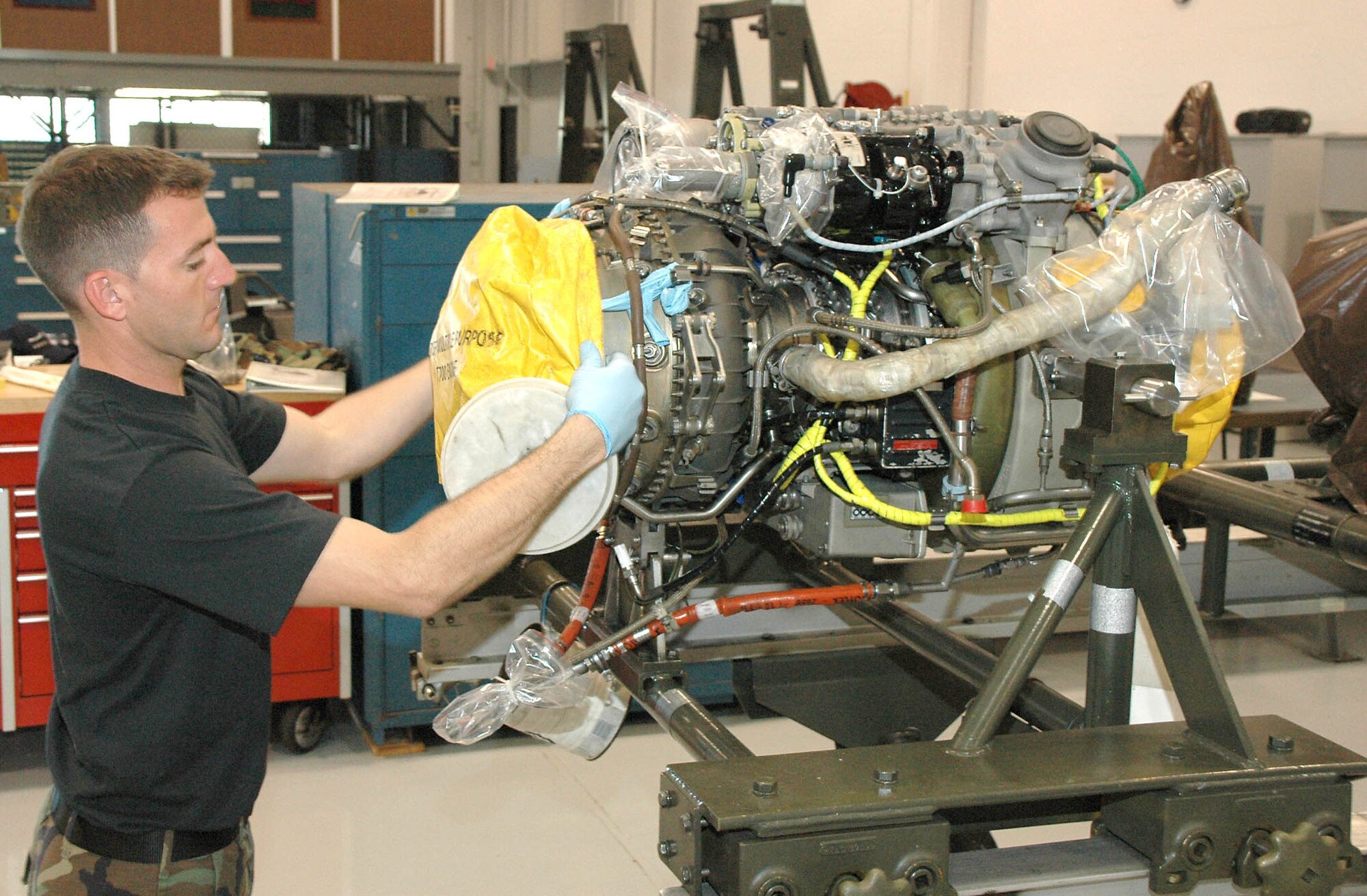 PATRICK AIR FORCE BASE, Fla. - Staff Sgt. David Rowlands Rowlands, Air Force Reserve engine mechanic, 920th Maintenance Propulsion Shop, places a protective cover on a T-700 engine from an HH-60G Pave Hawk rescue helicopter during a recent 920th Rescue Wing Unit Training Assembly.  Leading from the front, Air Force reservists undergo the same training as Regular Component Airmen and meet or exceed the same high standards. (U.S. Air Force Photo\Raymond F. Padgett)