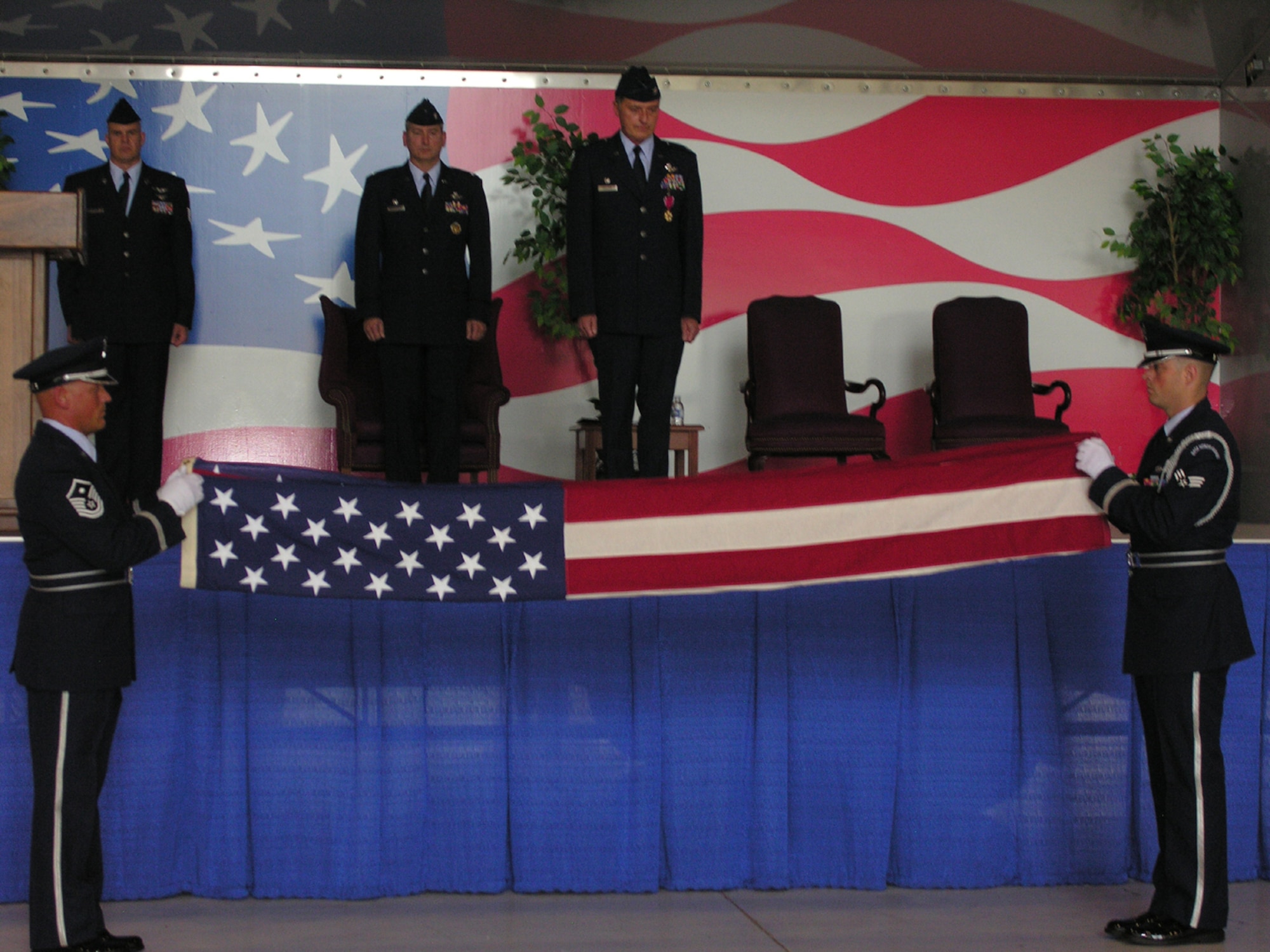 SEYMOUR JOHNSON AIR FORCE BASE, N.C. -- Col. Mark Kolleda (center stage) looks on as two members of the 916th Honor Guard perform the traditional flag folding ceremony. The flag was presented to Colonel Kolleda as part of his retirement ceremony during the April unit training assembly. Colonel Kolleda retires as commander of the 916th Operations Group. U.S. Air Force photo/Ms. Donna Lea