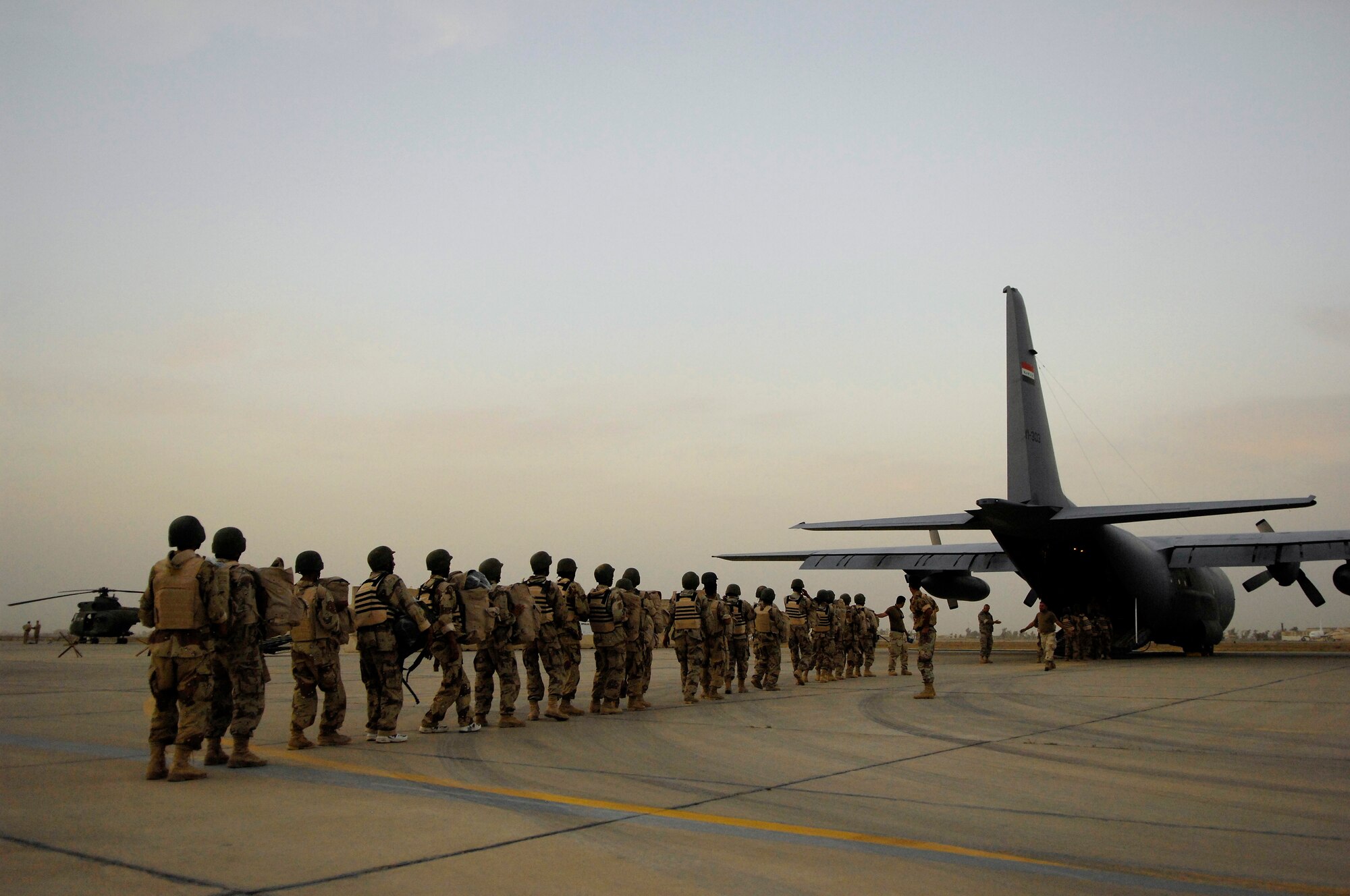 Members of the Iraqi Army load on an Iraqi Air Force C-130 Hercules before a flight to Basra, Iraq at New Al Muthana Air Base, Baghdad, Iraq on April 1, 2008. They are part of a group of 300 soldiers being transported to Basra by the Iraqi Air Force today. To date, all processing, loading and transporting of the Iraqi equipment and troops is being conducted by the Iraqi Air Force. The Iraqi Air Force has been flying several tons of ammunition and supplies as well as hundreds of troops to Basra daily with two C-130 Hercules during 24 hour operations. U.S. Air Force photo/Tech. Sgt. Jeffrey Allen
