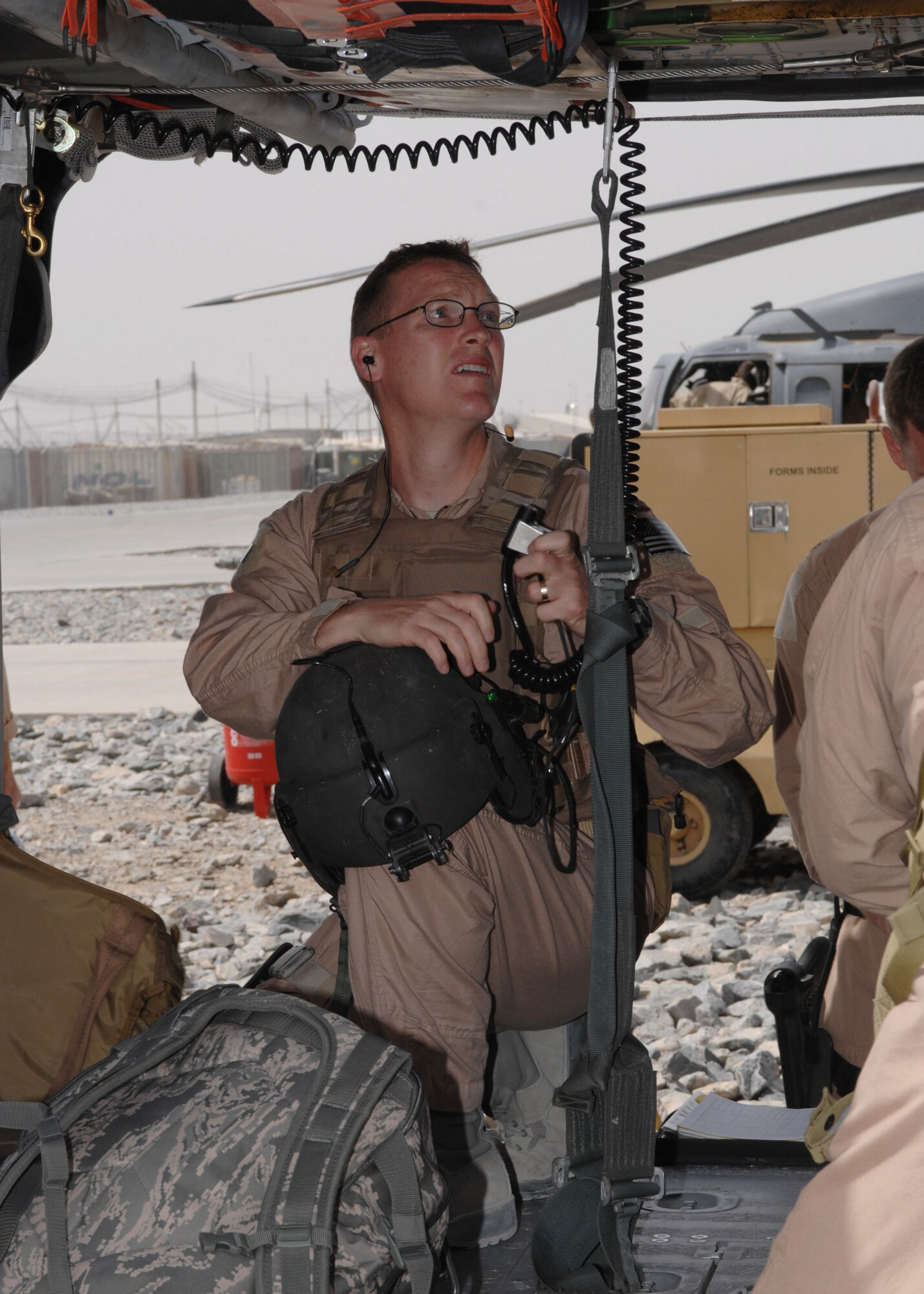 KANDAHAR AIR FIELD, Afghanistan – Maj. John Buterbaugh, 305th Expeditionary Rescue Squadron doctor, prepares his gear for a mission during an alert call here March 31.  Major Buterbaugh is deployed from the 306th Rescue Squadron, Davis-Mothan Air Force Base, Ariz. (U.S. Air Force photo by Master Sgt. Demetrius Lester)
