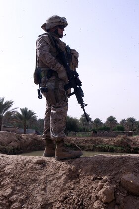 Sgt. Robert M. Ainley, a civil affairs Marine with Detachment 1, Civil Affairs Team 3, 2nd Battalion, 11th Marine Regiment, Regimental Combat Team 5, surveys his surroundings near a water treatment plant in the Hit, Iraq, April 23. The water treatment is one of the many projects the Iraqi government has taken control of since Hit was turned over to provincial government. CAT 3 helps local officials with making decisions, but encourages the Iraqis to find a solution to the problem without relying on Coalition forces.