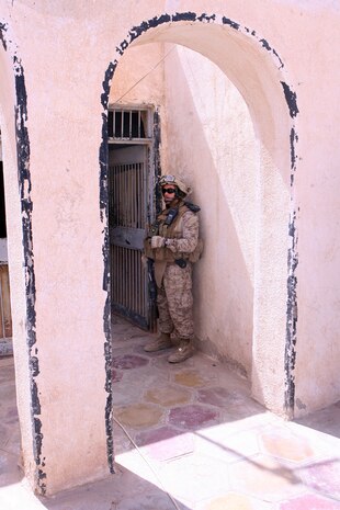 Sgt. Robert M. Ainley, a civil affairs Marine with Detachment 1, Civil Affairs Team 3, 2nd Battalion, 11th Marine Regiment, Regimental Combat Team 5, posts security while other Marines with CAT 3 meet with city officials in Hit, Iraq, April 23. The Hit city council meets once every two weeks to discuss different topics that will concern the provincial government and how they will be dealt with.