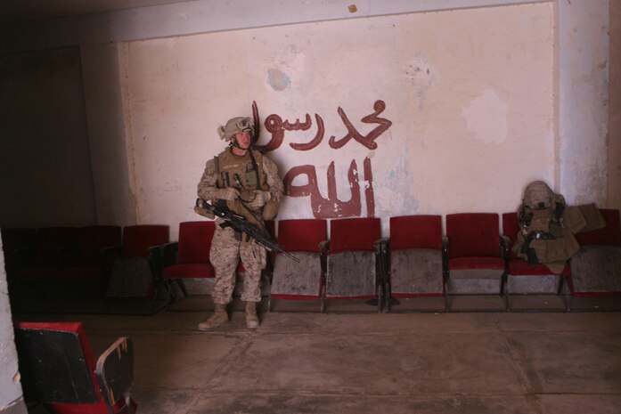 Cpl. Brendan A. Ryan, security chief for Civil Affairs Team 3's Detachment 1, posts security while his team meets with city officials to discuss progress of city projects. The civil affairs team, serving with 2nd Battalion, 11th Marine Regiment, Regimental Combat Team 5, encourages city officials to find Iraqi solutions to Iraqi problems.