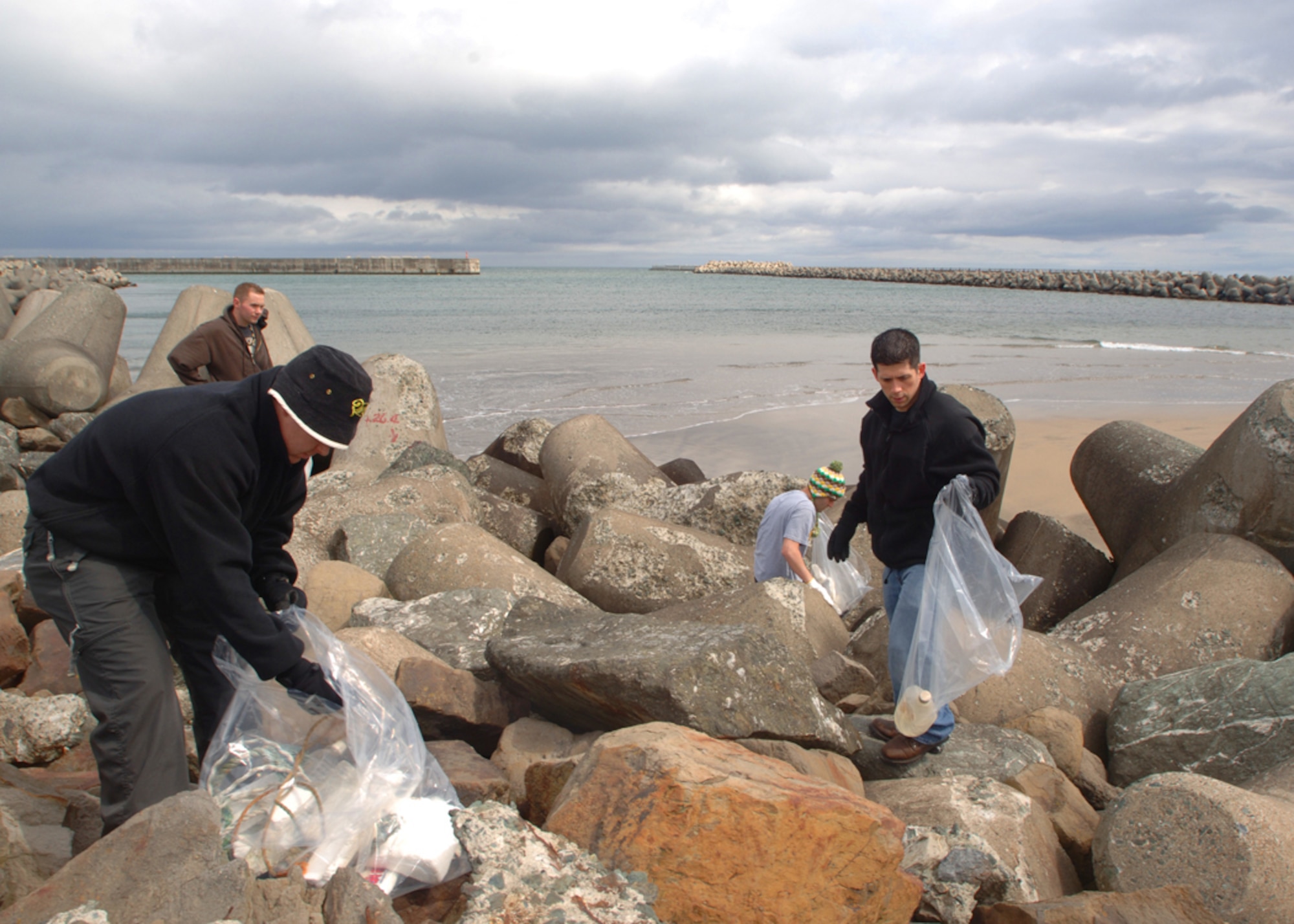 MISAWA AIR BASE, Japan -- Volunteers work to clean up trash during the fish port and beach clean-up here April 12, 2008.  This is the 11th annual fish port and beach clean-up held in recognition of Earth Day.  (U.S. Air Force photo by Senior Airman Robert Barnett)