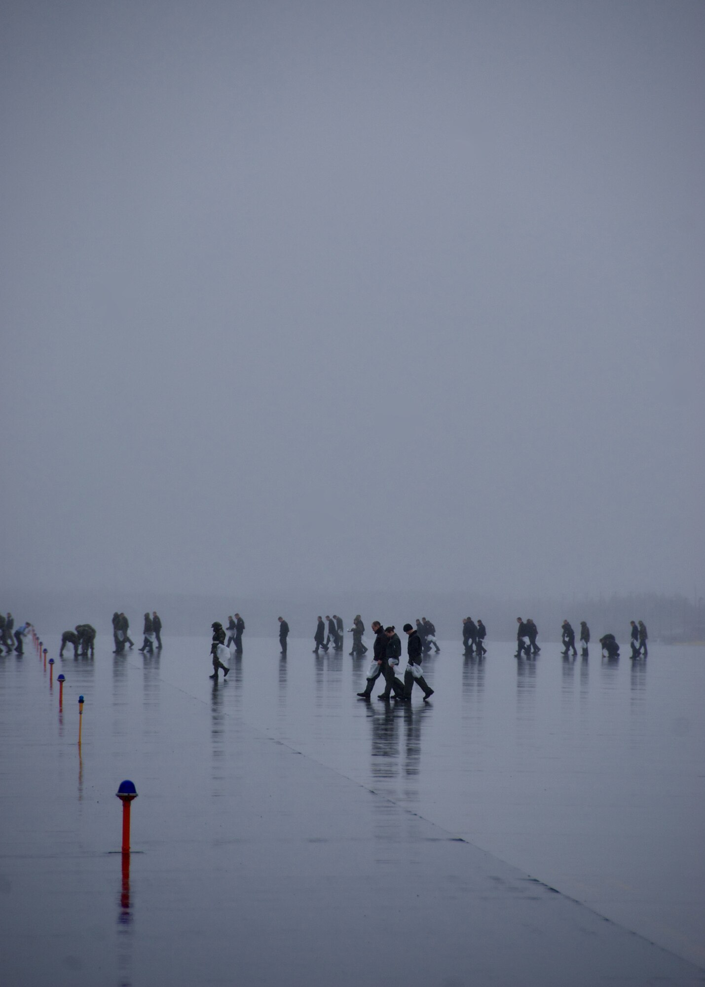 MISAWA AIR BASE, Japan -- Servicemembers cover the flightline in search of debris during the annual base-wide FOD walk here April 11, 2008. As an incentive to pick-up as much debris as possible, organizers of the FOD walk hid "golden bolts" that if found could be redeemed for prizes. (U.S. Air Force photo by Senior Airman Chad Strohmeyer)