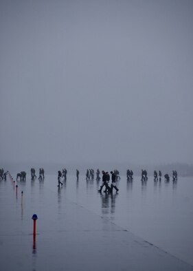 MISAWA AIR BASE, Japan -- Servicemembers cover the flightline in search of debris during the annual base-wide FOD walk here April 11, 2008. As an incentive to pick-up as much debris as possible, organizers of the FOD walk hid "golden bolts" that if found could be redeemed for prizes. (U.S. Air Force photo by Senior Airman Chad Strohmeyer)