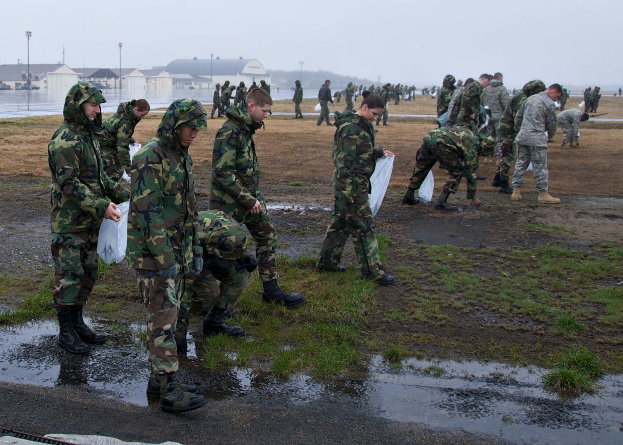 MISAWA AIR BASE, Japan -- Air Force members search the airfield for debris during the base FOD walk here April 11, 2008. Such procedures are done on a daily basis by flightline personnel, but once a year the entire base helps out. (U.S. Air Force photo by Senior Airman Chad Strohmeyer)