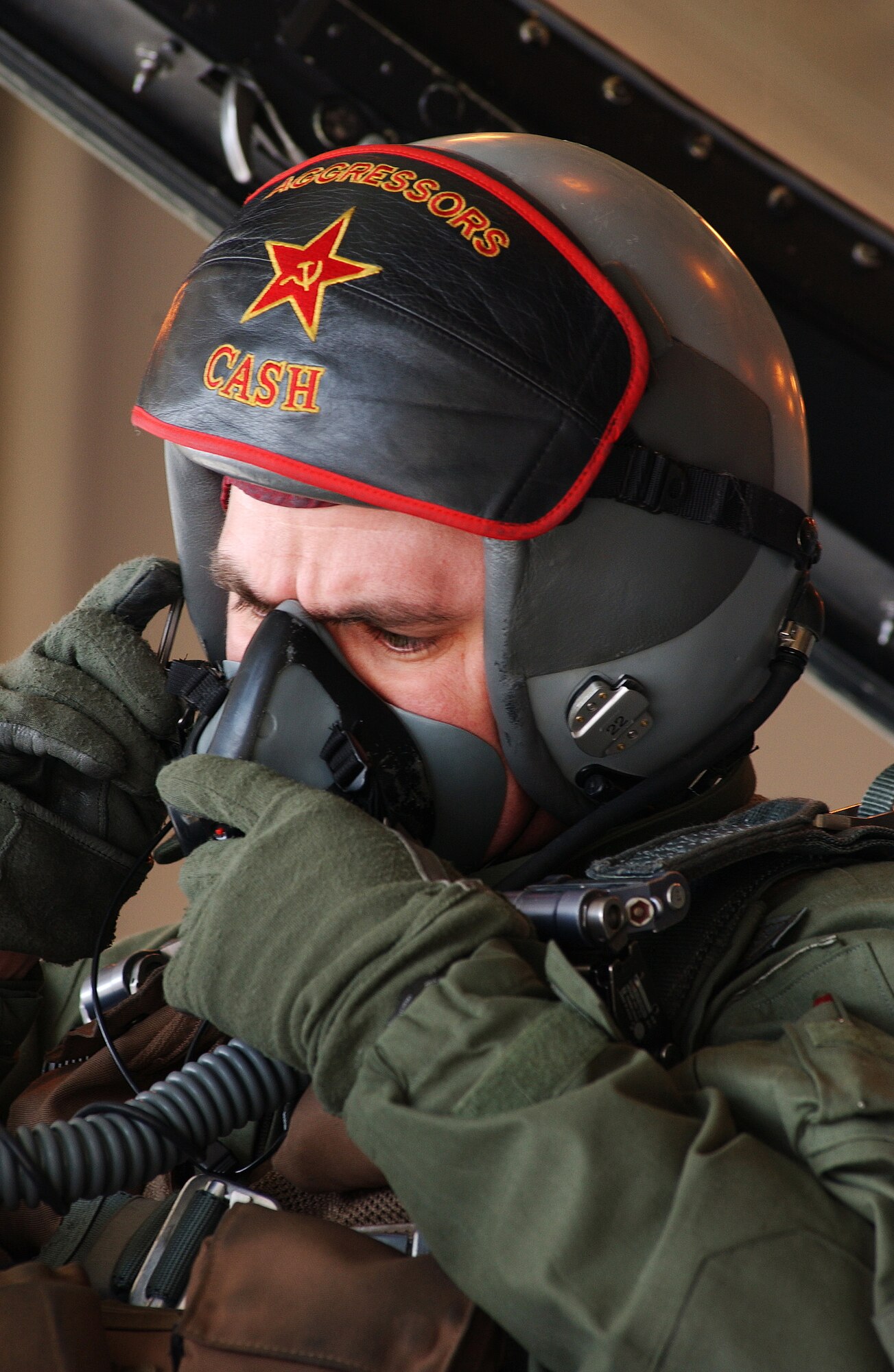 Capt. Jonathan Mumme fastens his oxygen mask prior to starting the engines of an F-16 Aggressor April 11, 2008, at Eielson Air Force Base, Alaska. During RED FLAG-Alaska 08-2 the 18th Aggressor Squadron act as the opposing force employing enemy tactics while engaging in aerial combat over the Pacific Alaskan Range Complex. Captain Mumme is a pilot assigned to the 18th AGRS. (U.S. Air Force Photo/Airman 1st Class Jonathan Snyder)