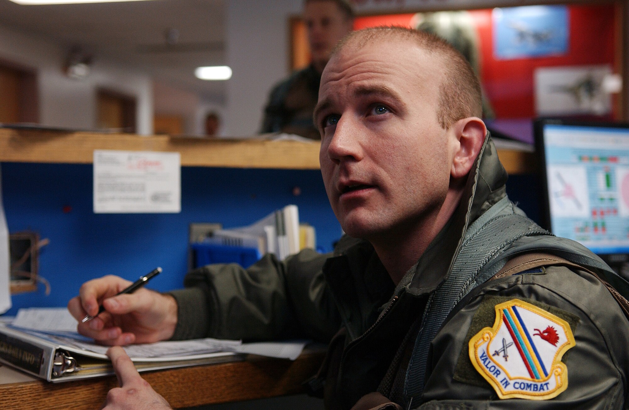 Capt. Corey Hermesch writes down information for his training mission on April 11, 2008, at Eielson Air Force Base, Alaska. During RED FLAG-Alaska 08-2 the 18th Aggressor Squadron acts as the opposing force employing enemy tactics while engaging in aerial combat over the Pacific Alaska Range Complex. Captain Hermesch is a pilot with the 18th AGRS. (U.S. Air Force Photo/Airman 1st Class Jonathan Snyder)