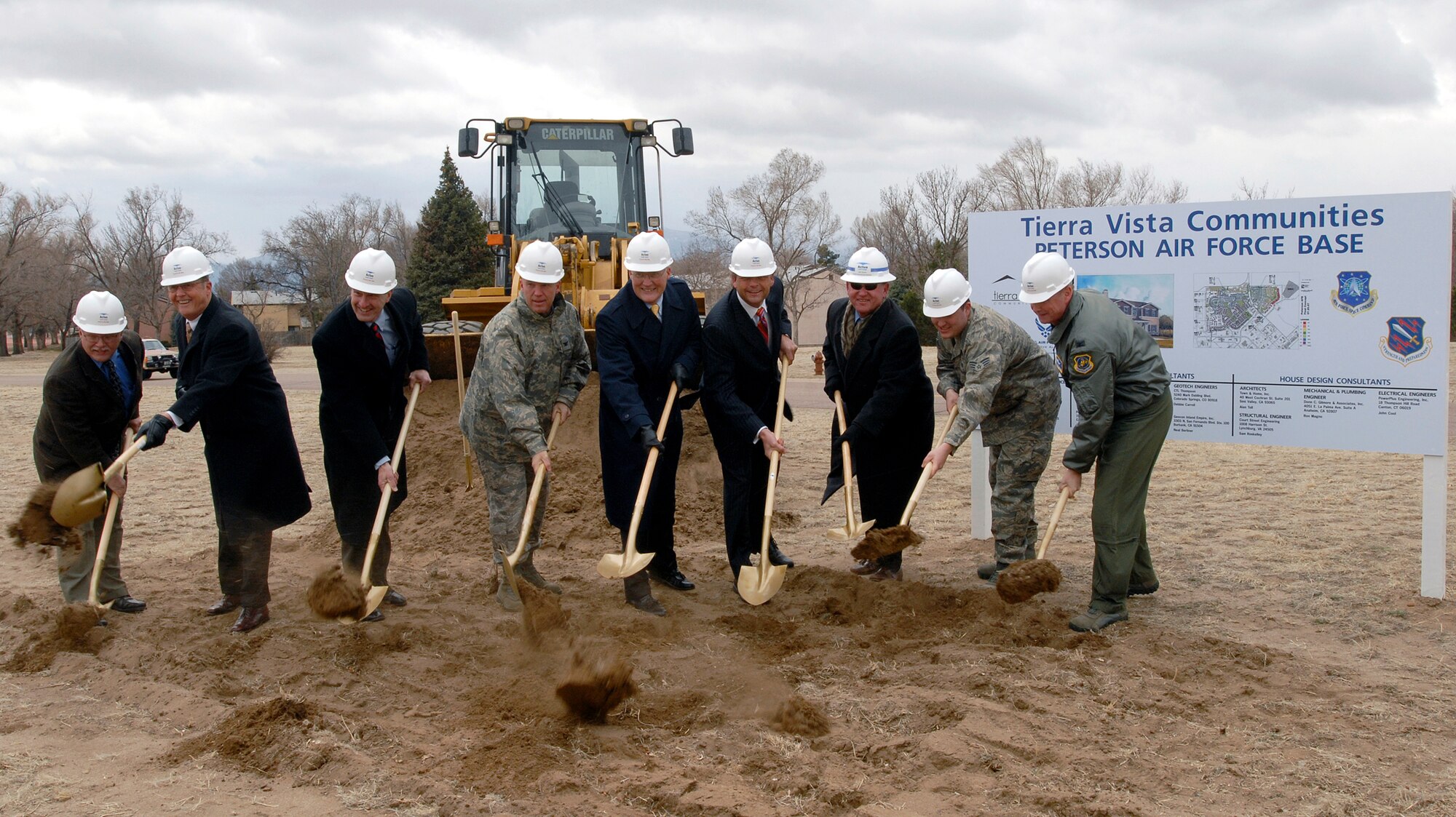 Col. Jay Raymond, 21st Space Wing commander, together with executives from the Actus Lend Lease company and wing leadership, turn over earth April 10 as each broke ground on Peterson Air Force Base's new privitazied housing, located in Colorado. The more than 550 houses are expected to increase base quality of life and provide industry-standard housing for military members stationed at Peterson. (U.S. Air Force photo/Joe Fischer)