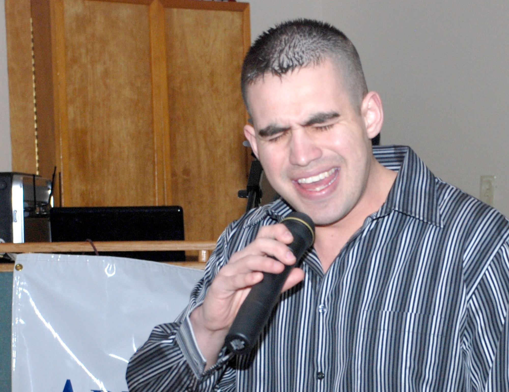 Senior Airman Randal Flatt, 90th Force Support Squadron, sings “Boot Scootin’ Boogie” by Brooks and Dunn during Warren Idol 3 April 4. Last week’s theme was country. This week is the final week of the competition, and the remaining contestants will be able to choose their own genre of songs (U.S. Air Force photos by 2nd Lt. Lisa Meiman).