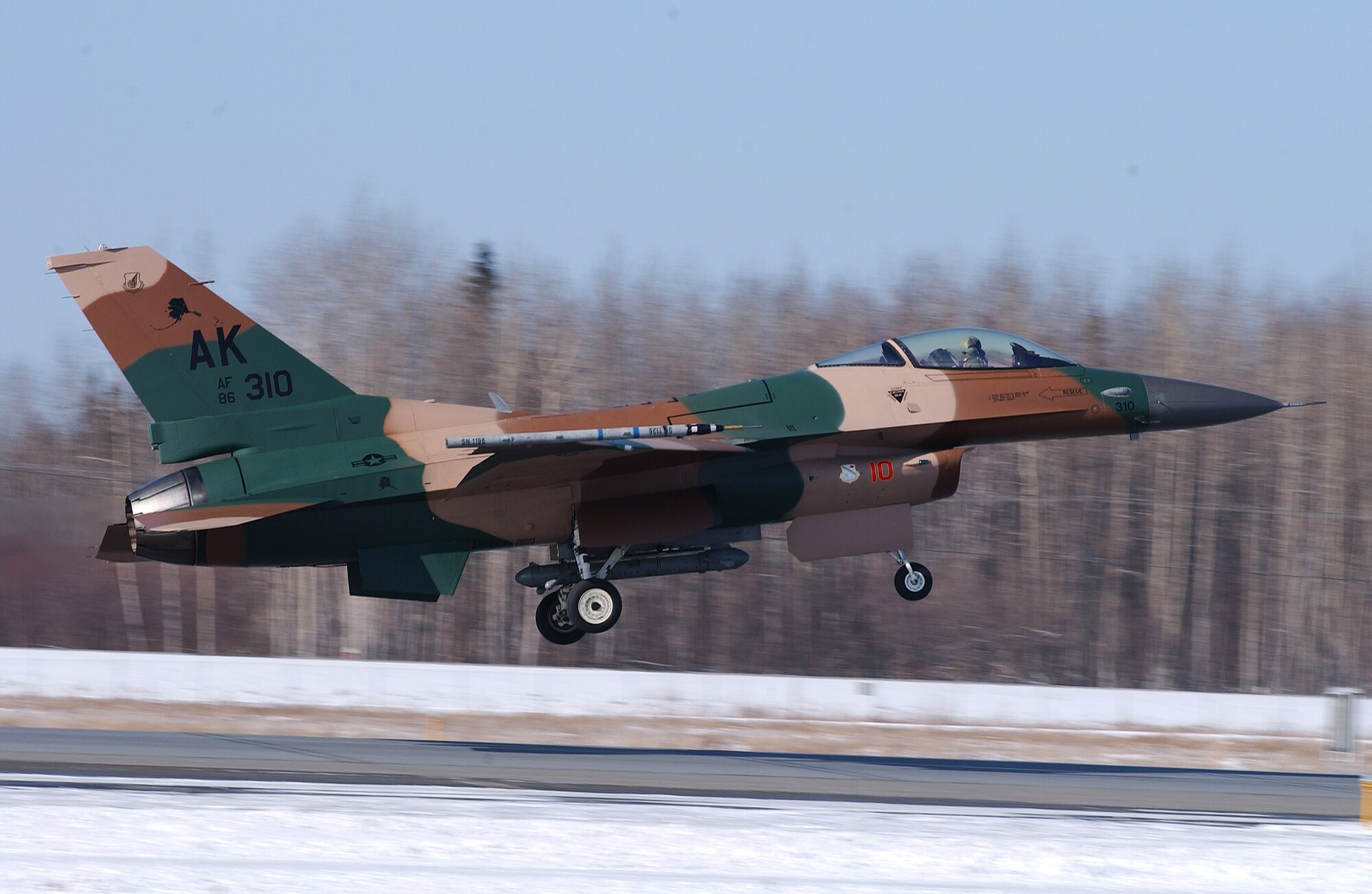 A F-16 Aggressor with the flogger flanker scheme takes off for a training mission at Eielson Air Force Base, Alaska April 11, 2008. RED FLAG-Alaska 08-2 is a Pacific Air Forces command directed field training exercise which provides joint offensive counter-air, interdiction, close air support and large force employment training in a simulated combat environment. The aircraft is assigned to the 18th Aggressor Squadron. (U.S. Air Force Photo/Airman 1st Class Jonathan Snyder)