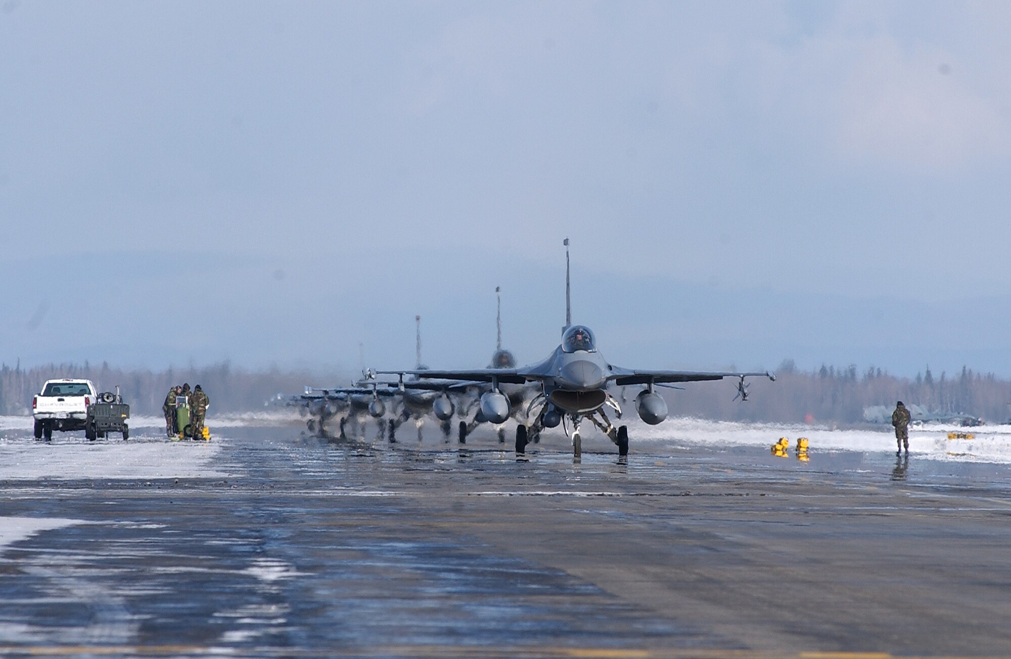 Several F-16 Fighting Falcons taxi down the flight line in a single file line at Eielson Air Force Base, Alaska. RED FLAG-Alaska 08-2 is a Pacific Air Forces command directed field training exercise which provides joint offensive counter-air, interdiction, close air support and large force employment training in a simulated combat environment. The aircraft is assigned to Luke Air Force Base, Ariz. (U.S. Air Force Photo/Airman 1st Class Jonathan Snyder)