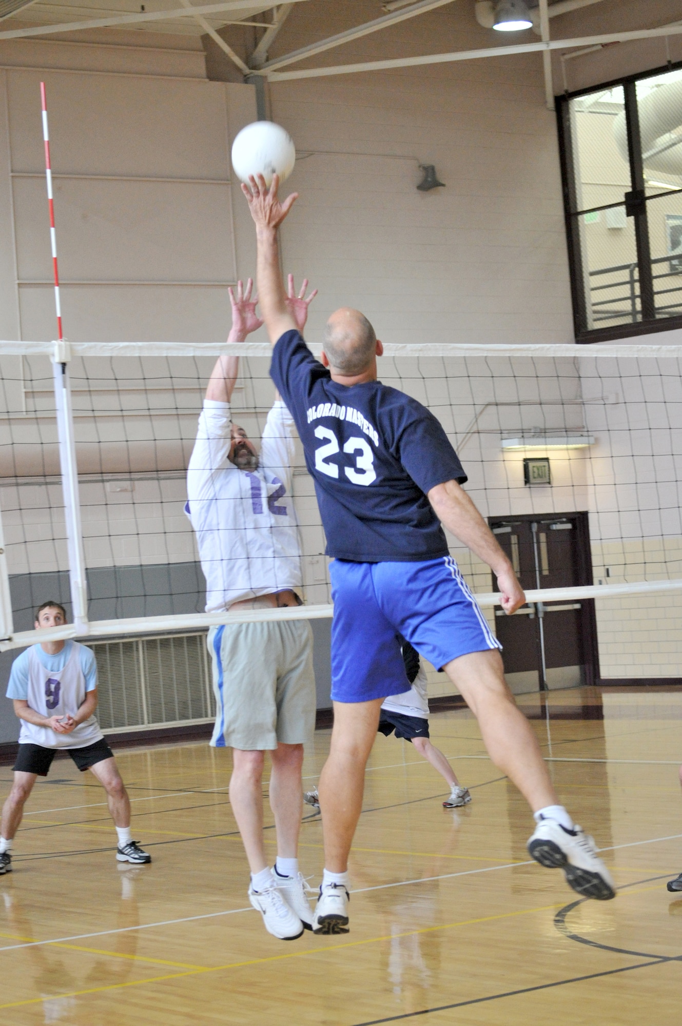 NORAD/NORTHCOM’s Jimmy Shaw, 23, tips a ball over a Team Colorado defender during action April 10 at the Peterson Fitness and Sports Center in Colorado. (Courtesy photo/Walt Johnson)