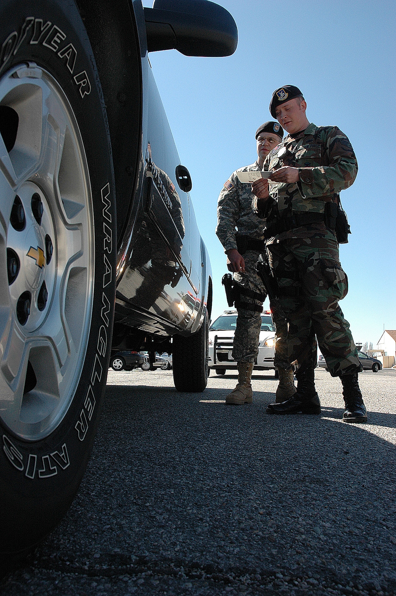 Private First Class Austin Harris watches on as Senior Airman Justin Moore runs through routine traffic stop procedures for an exercise April 12 during a training weekend.